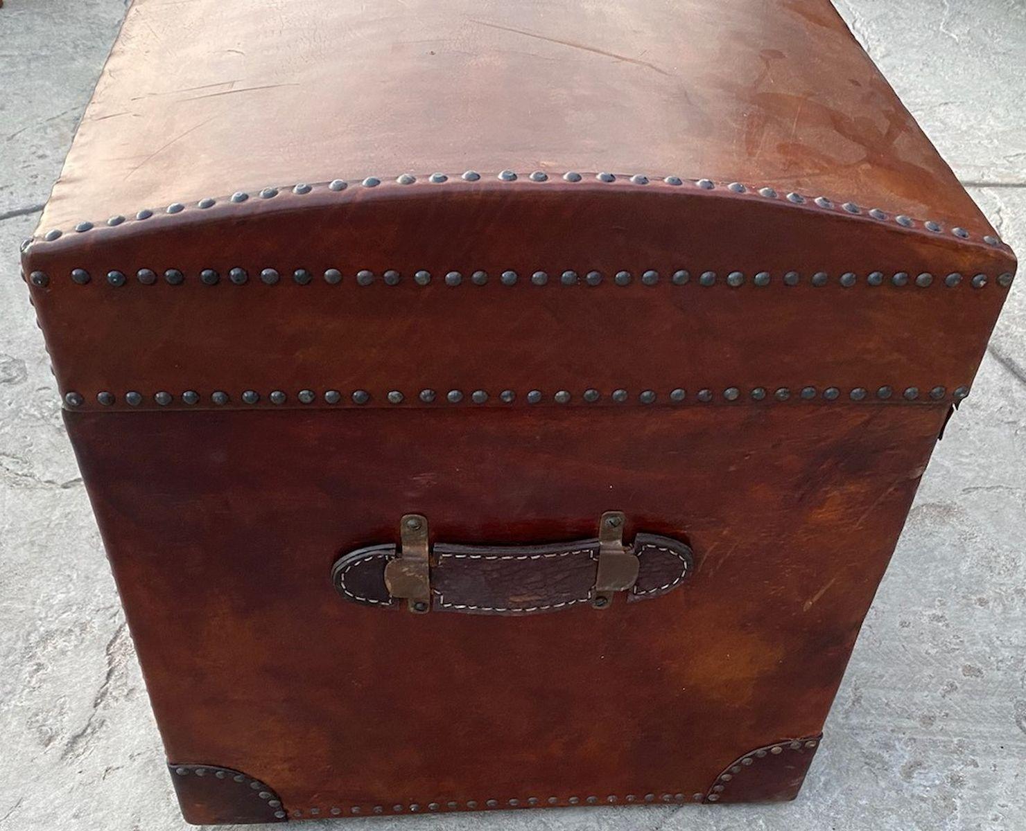 This fine handmade all leather dome top trunk with a nice wool grey flannel liner. This is in fine condition and sturdy.