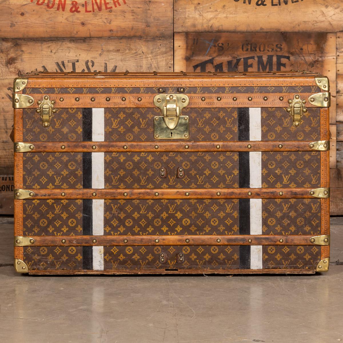 Antique early 20th century cabin trunk made by Louis Vuitton. Covered in the world famous LV monogrammed canvas, with its lozine borders and brass fittings, it would have been the top of the line even at the time of purchase some 100+ years ago.