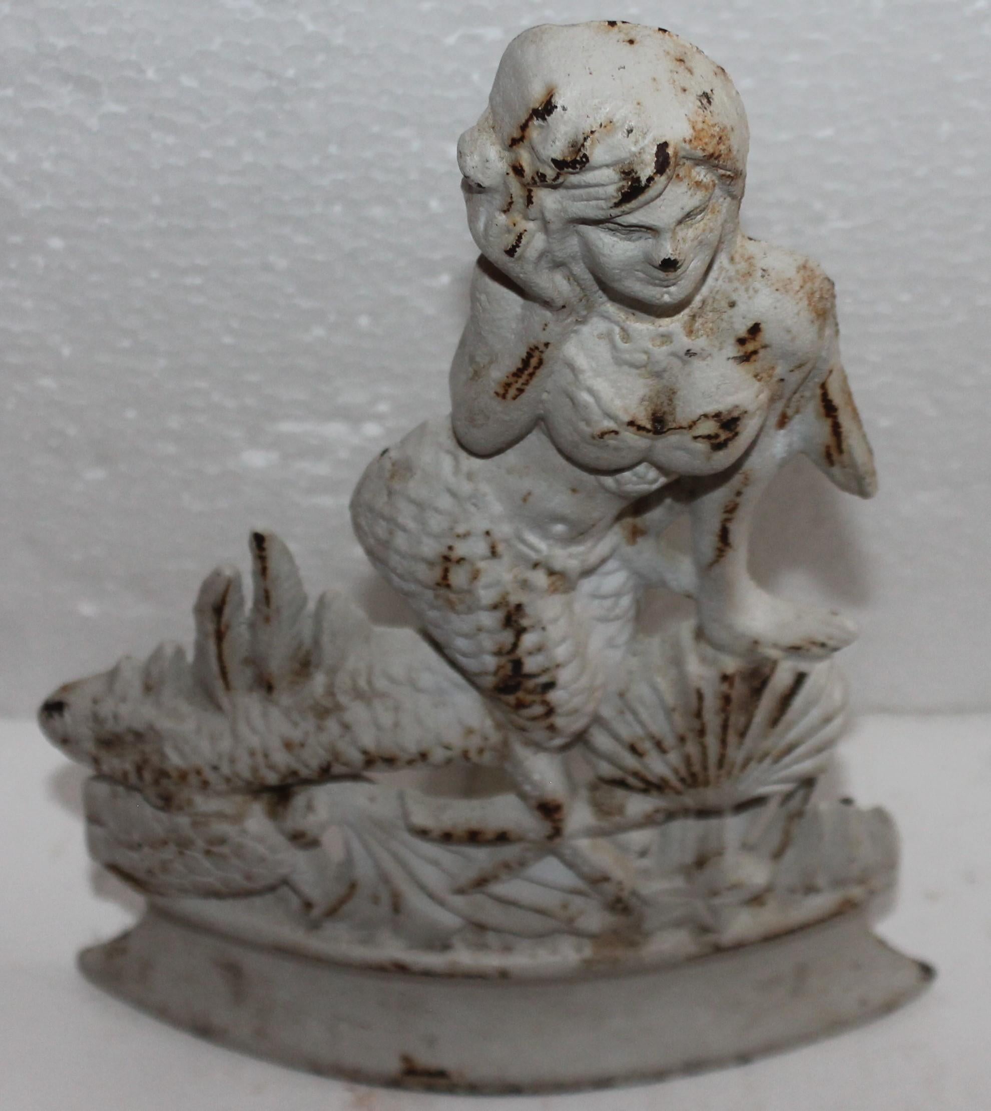 20th century mermaid original cream painted cast iron door stop. The condition is good with wear consistent from age and use.