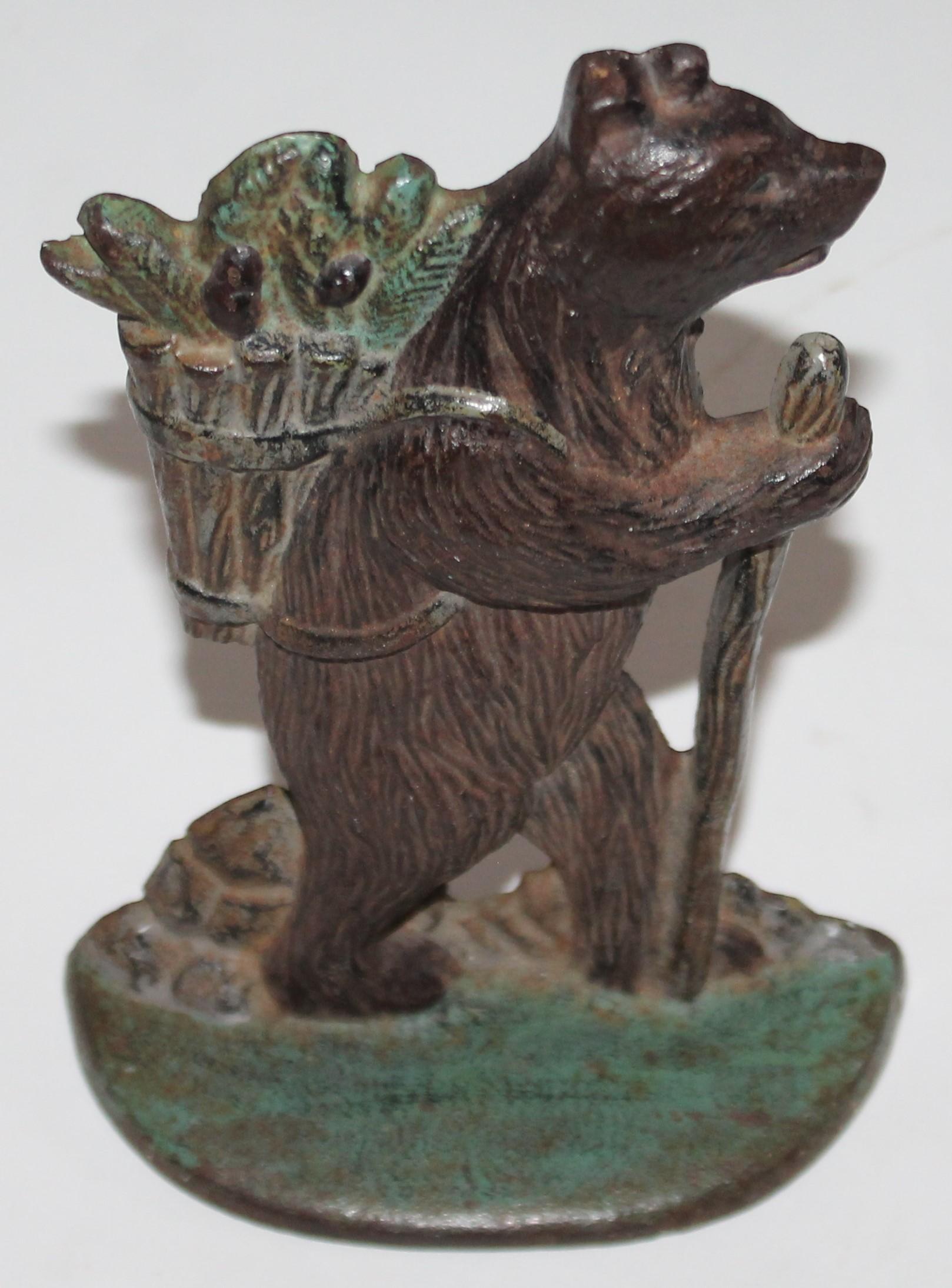 This fun and folky bear doorstop is in good condition with worn paint on the front of the bear.