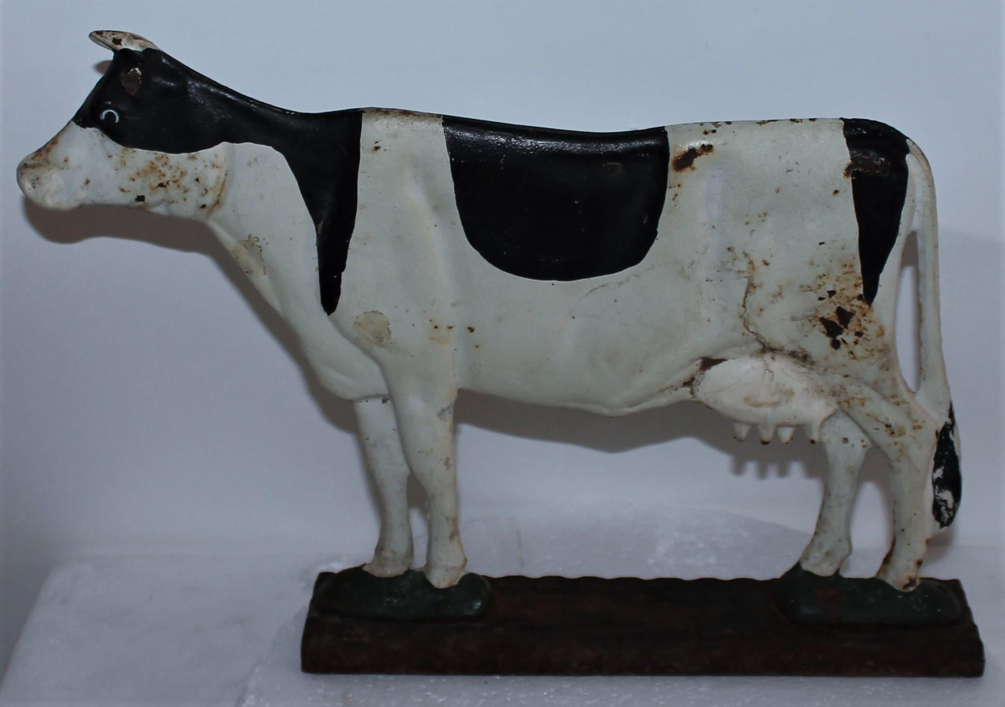 20Thc Original painted cast iron double sided cow doorstop. The base paint is worn off and minor paint loss in areas of the cow.
