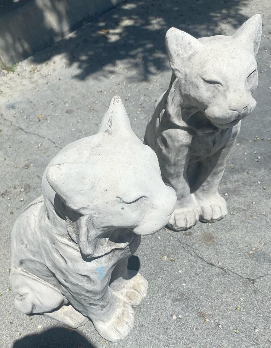 Pair of concrete or garden cats in old aged surface. Wonderful & folky Lynx cats.