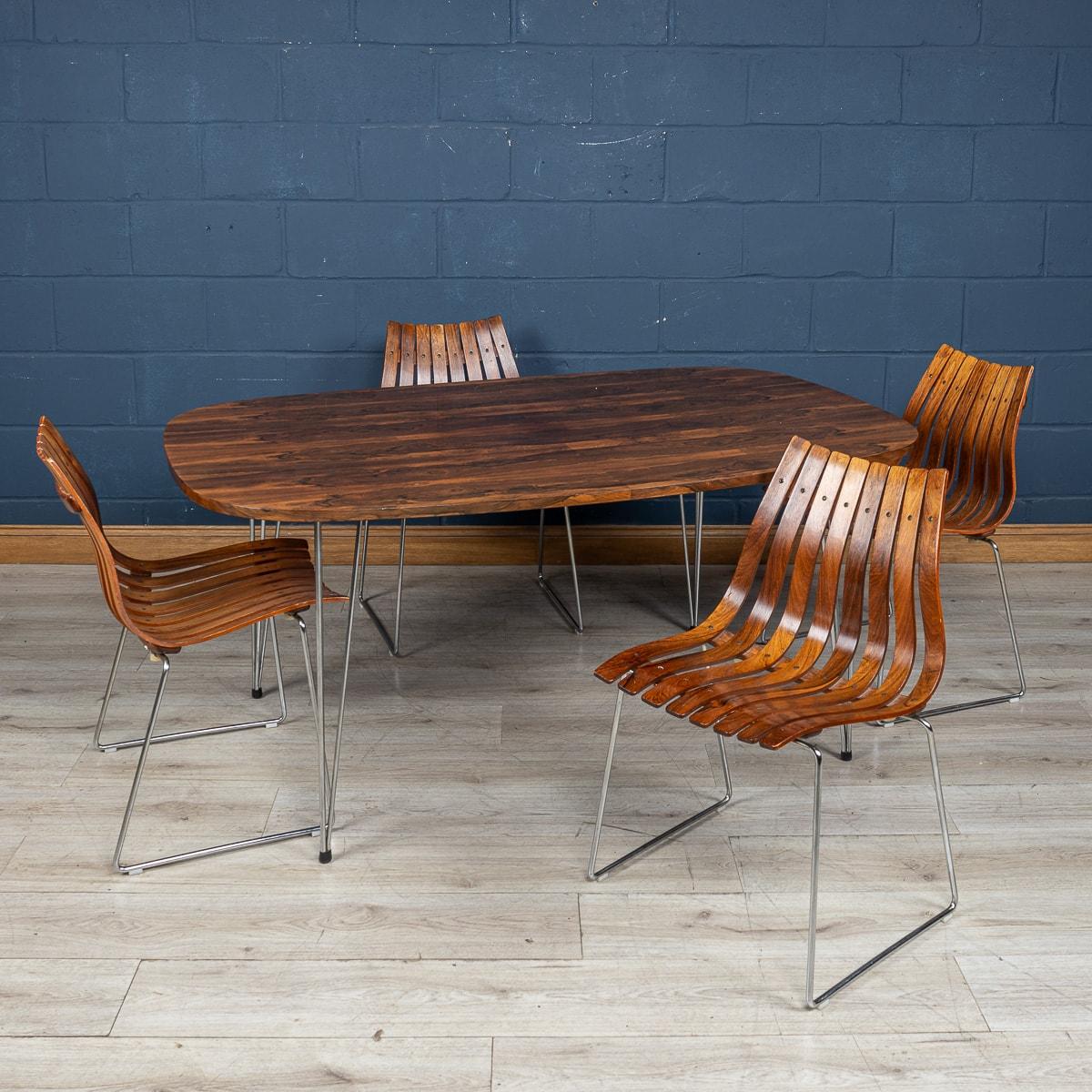 A rosewood dining table and chairs by Hans Brattrud for Hove Mobler, Norway, 1960s. This stunning set consists of four rosewood 'Scandia' dining chairs on tubular steel supports, together with a 'Scandia' dining table. The table top is formed from