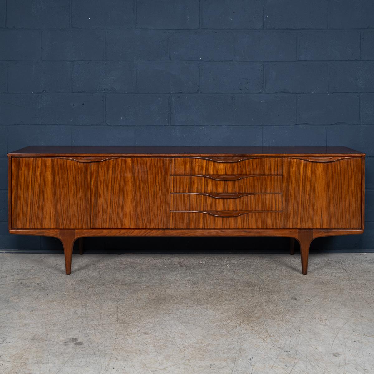 A striking example of mid-century design for your home, this rare vintage sideboard by Tom Robertson for A.H. McIntosh Furniture of Kirkcaldy, Scotland features clean Scandinavian-modern lines crafted from richly grained British woods using