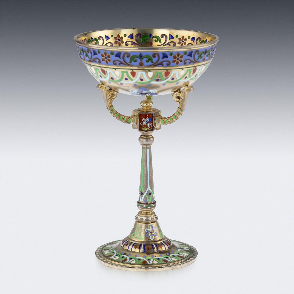 Antique early 20th century Russian solid silver-gilt sherbet cup on stand, decorated with plique-à-jour enamel rim and guilloché enamel interior, supported by three foliate and beaded arms rising from a hexagonal stem enameled with coats of arms of