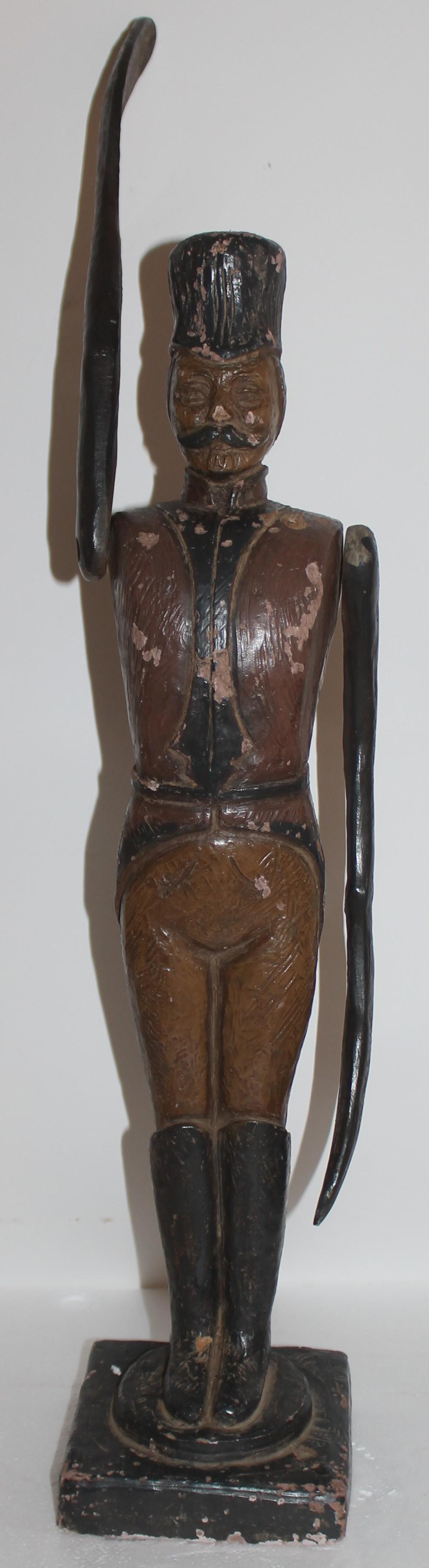 This folk terracotta sculpture is depicting a English soldier in uniform - The jointed arms are attached by screws in the shoulder area. It has chips or wear in areas see pictures for close up wear. This is a later 20th c copy of an early 19thc