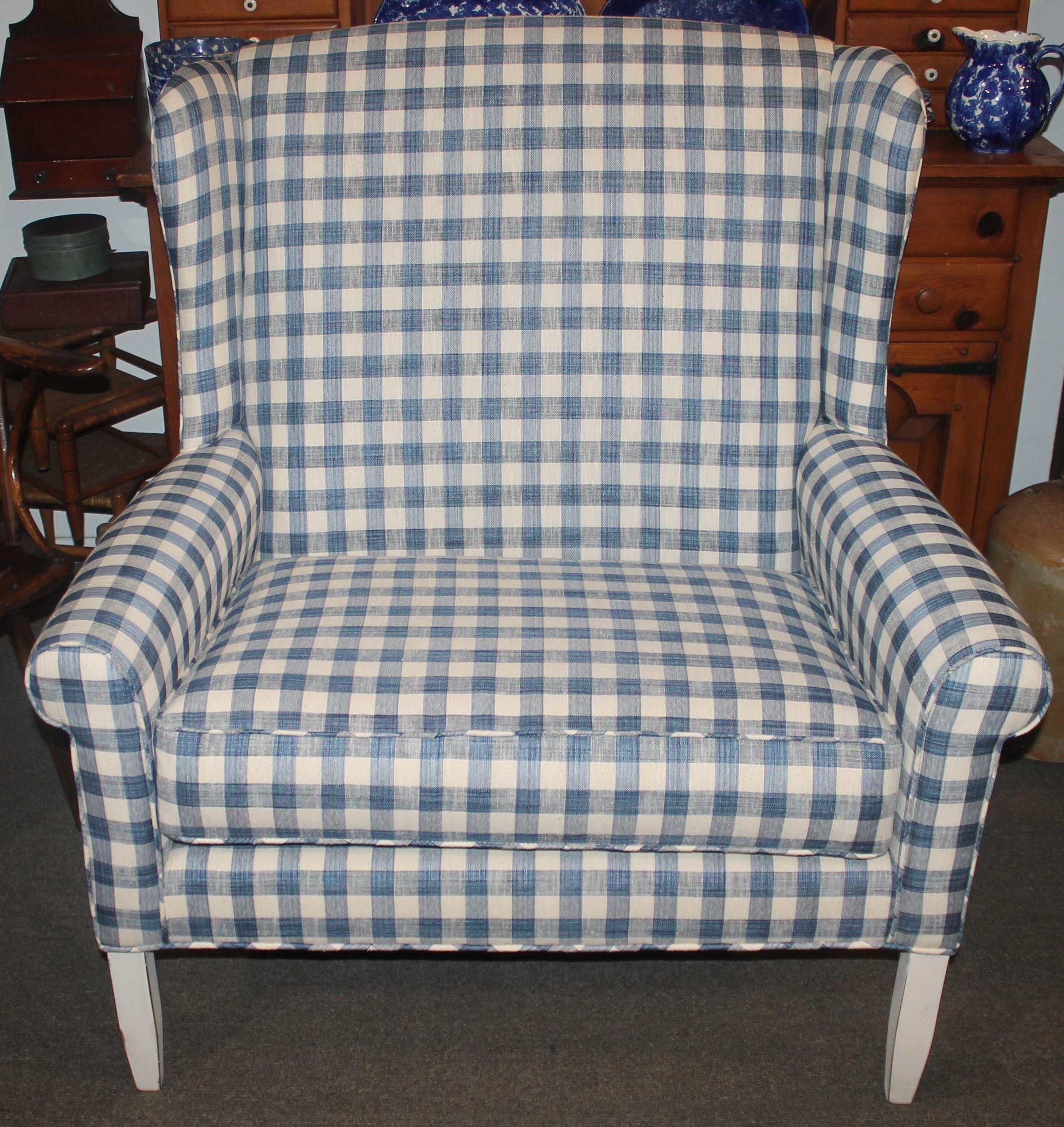 This fantastic wingback love seat is in amazing condition and great form. The repro. blue & cream homespun linen upholstered love seat is amazing. The new fabric looks like early 19thc fabric. The frame is in a worn white paint. The cushion has a