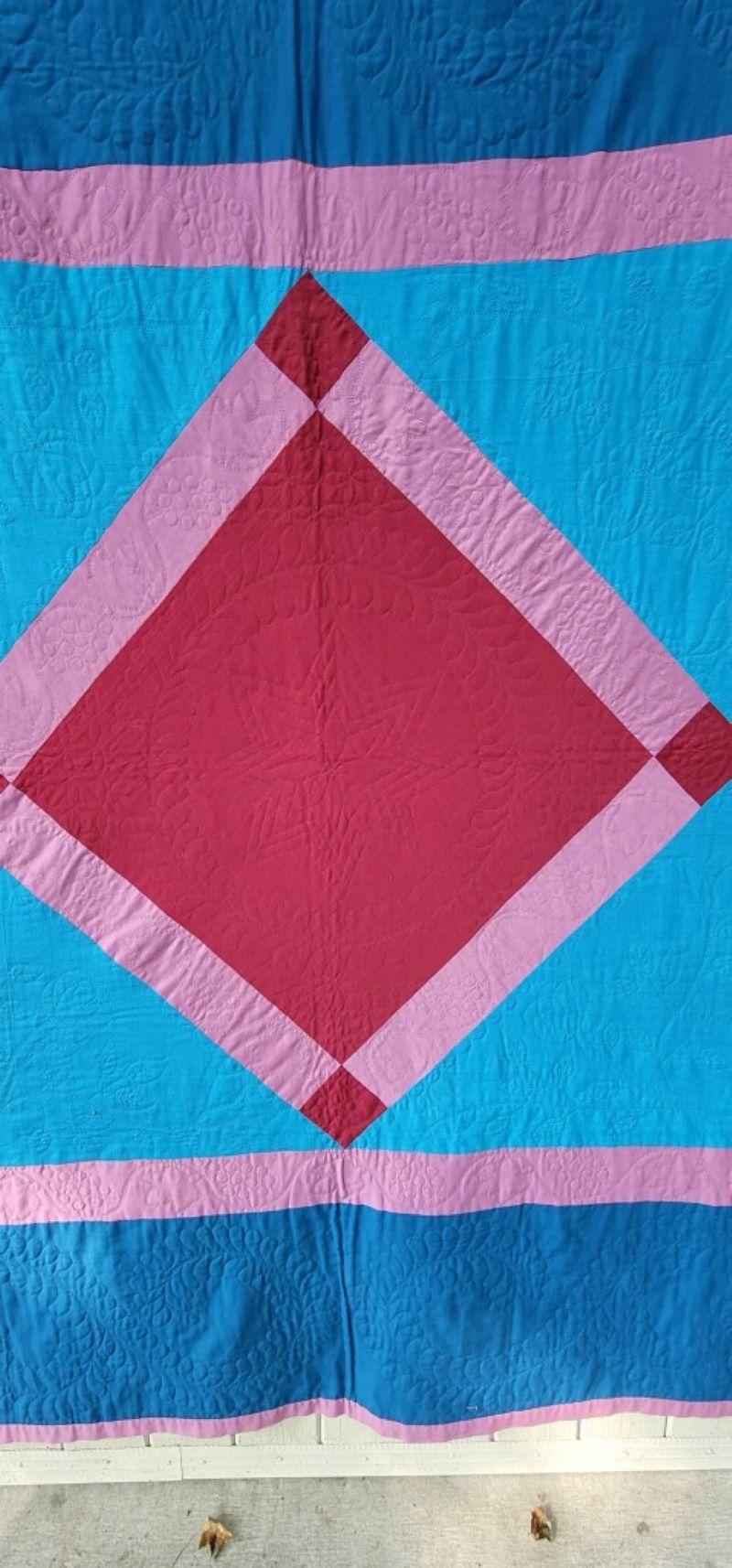 This fine and unusual all wool diamond in a square quilt from Lancaster County,Pennsylvania. This fine five color diamond in a square is in great condition. This quilt has very fine quilting with grapes and flowers quilted through out. The backing