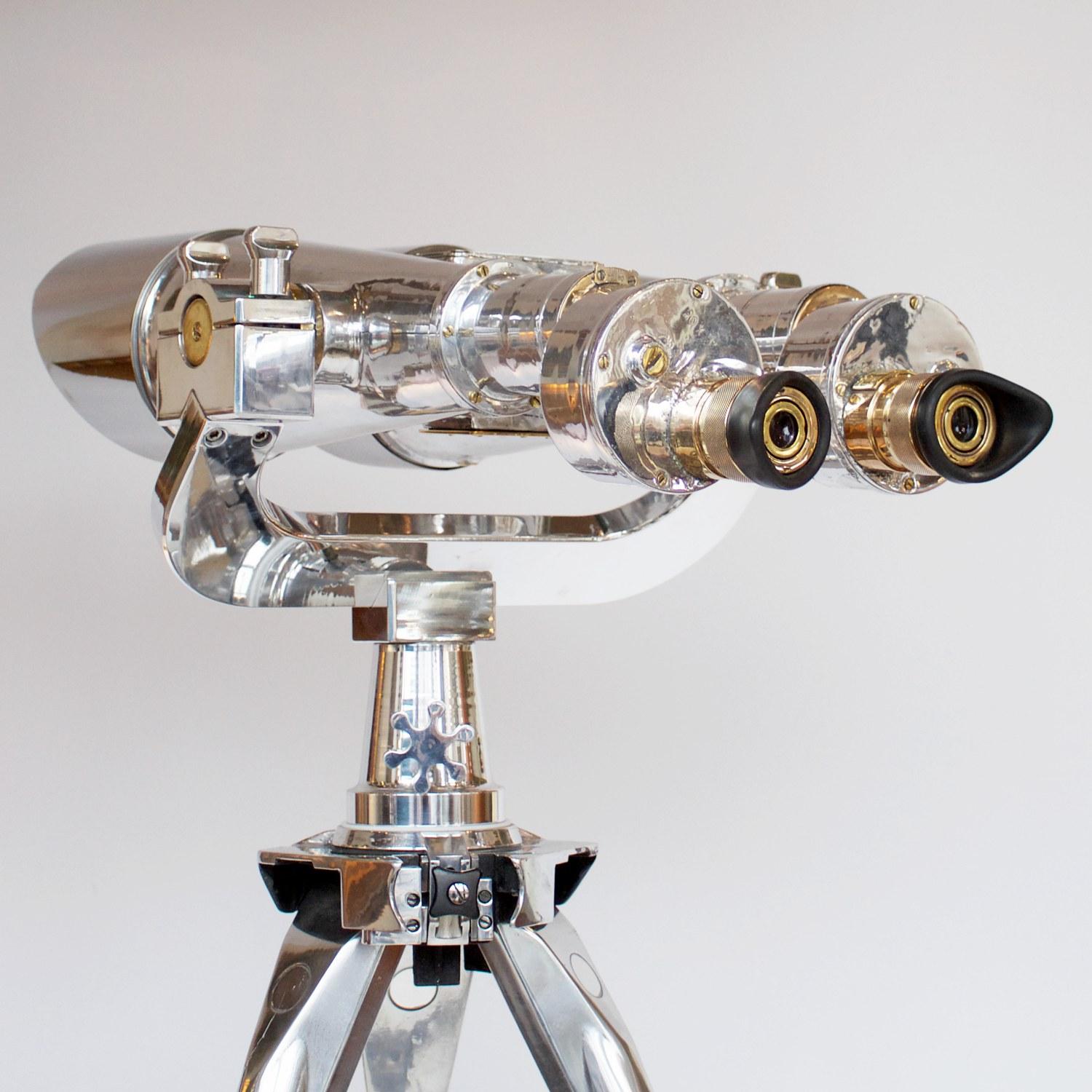 Pair of chromed metal and brass Nikon 20x120 WWII Naval Binoculars. Set on an original 1940s military, re-polished metal stand.

20x magnification with 120mm objective lenses. Paint stripped and metal polished. Optics fully