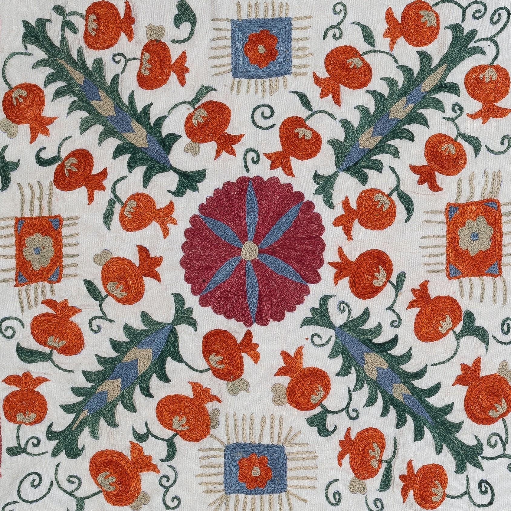 Infuse your home with the rich heritage of Central Asia with this exquisite Hand-Embroidered Suzani Cushion Cover, crafted by skilled artisans in Uzbekistan. This stunning textile is a true work of art, featuring intricate, traditional Suzani