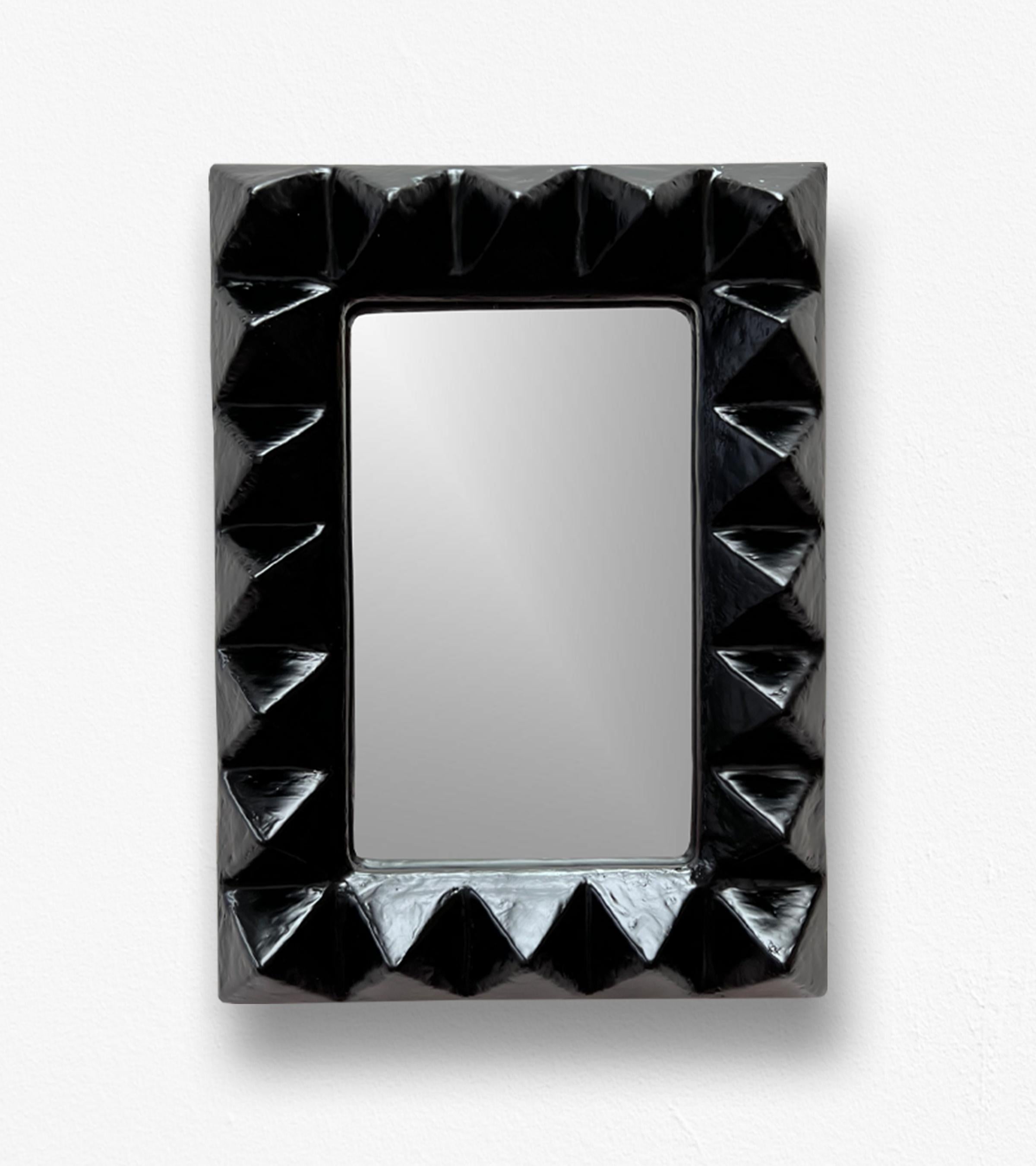 Introducing the Le Stud Mirror, a bold, architectural wall mirror that celebrates texture, form, and irreverent style. 

This sculptural piece redefines the traditional mirror with its robust, hand-carved frame and rhythmic geometry. Handcrafted