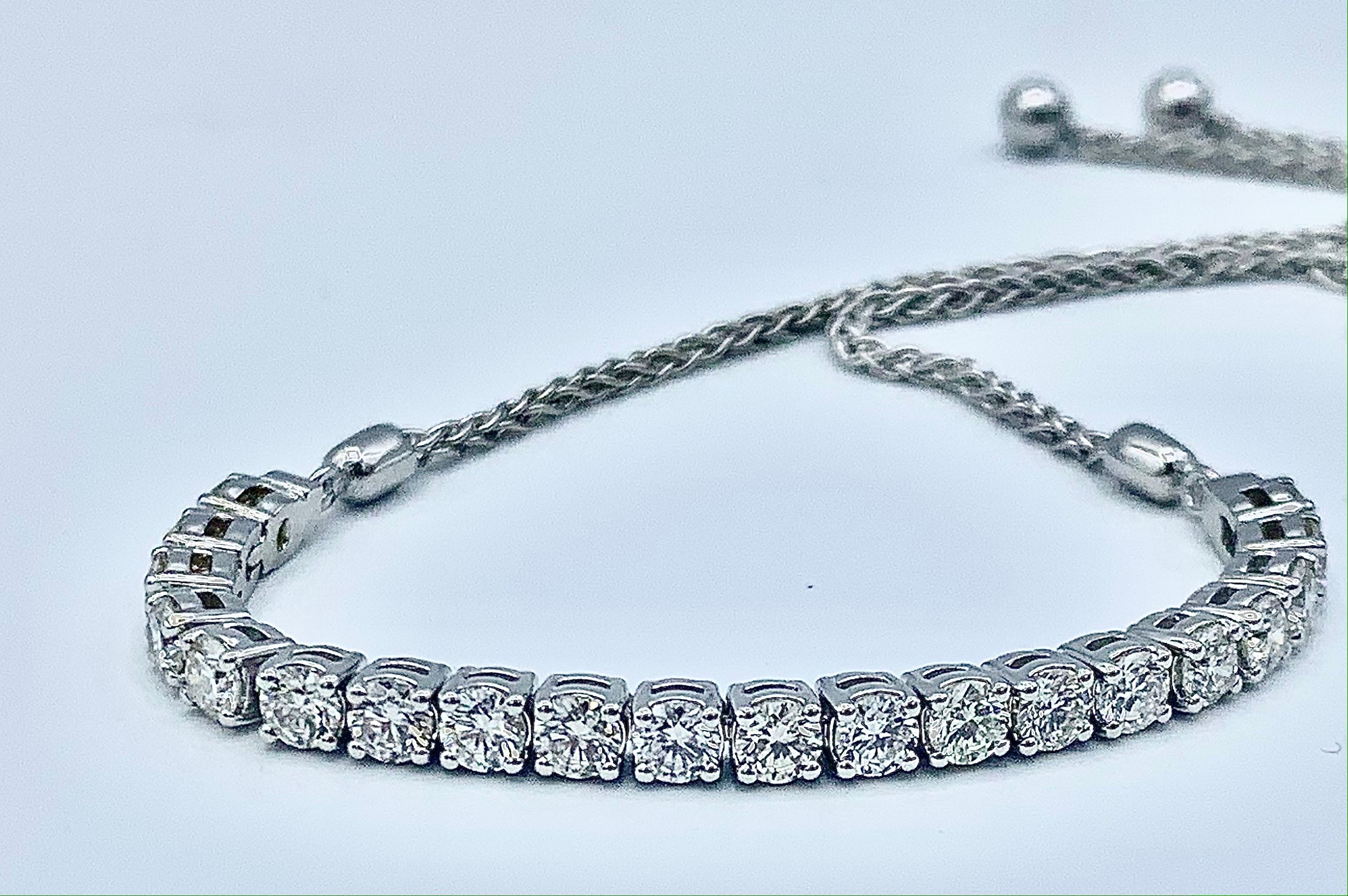 This unique twist on a tennis bracelet consists of 14 karat white gold and 20 round VS2, I-J diamonds totaling 2.1 carats. The bracelet is finished by a 14 karat white gold wheat chain that is adjustable like a draw string with a white gold circle