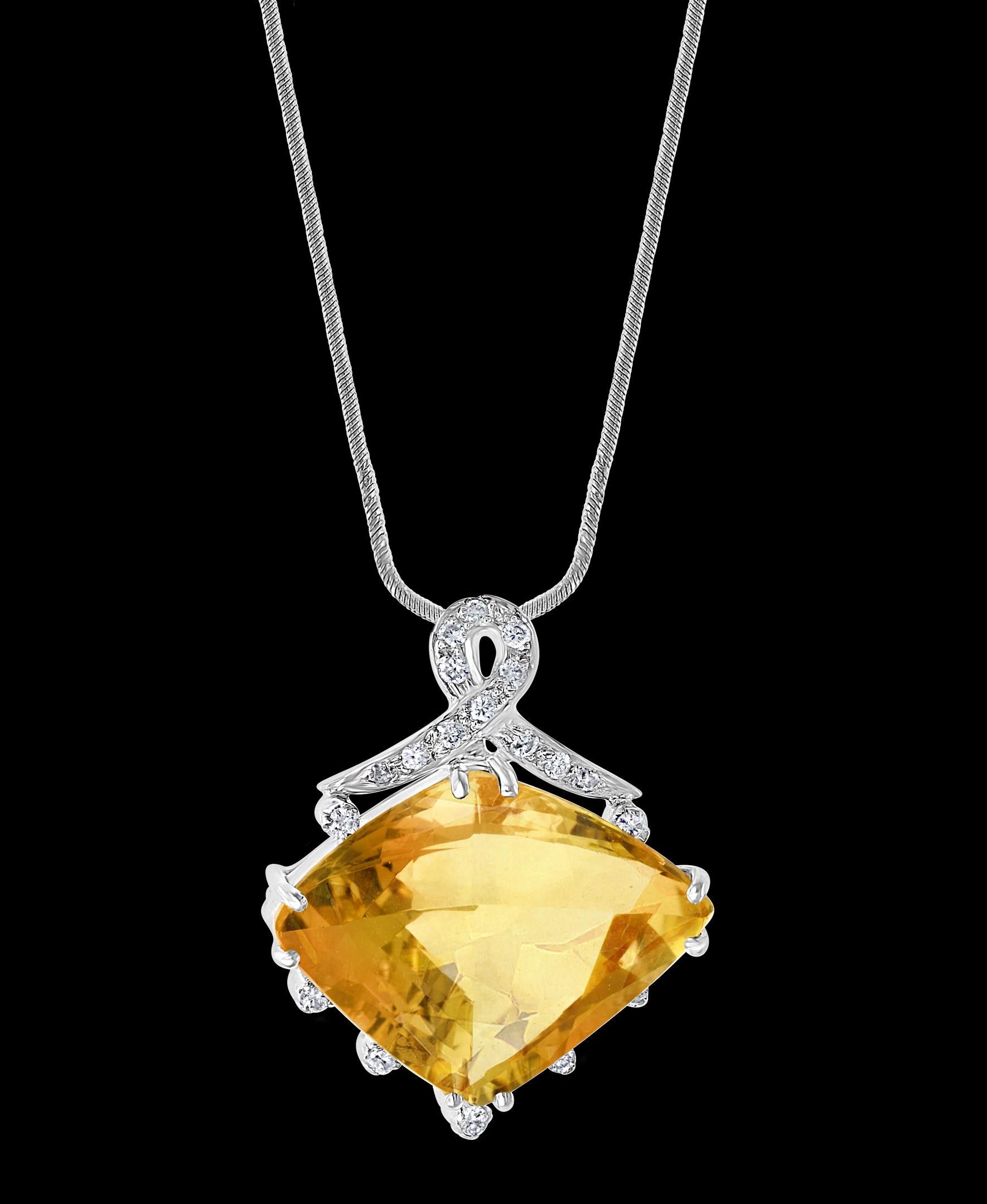   21 Carat Lemon Topaz and Diamond Pendant Necklace Enhancer, 18 Karat White Gold
This spectacular Pendant Necklace  consisting of a single Lemonn Topaz approximately 21 Carat.  The Stone   is surrounded by approximately 0.30 Carats of  brilliant