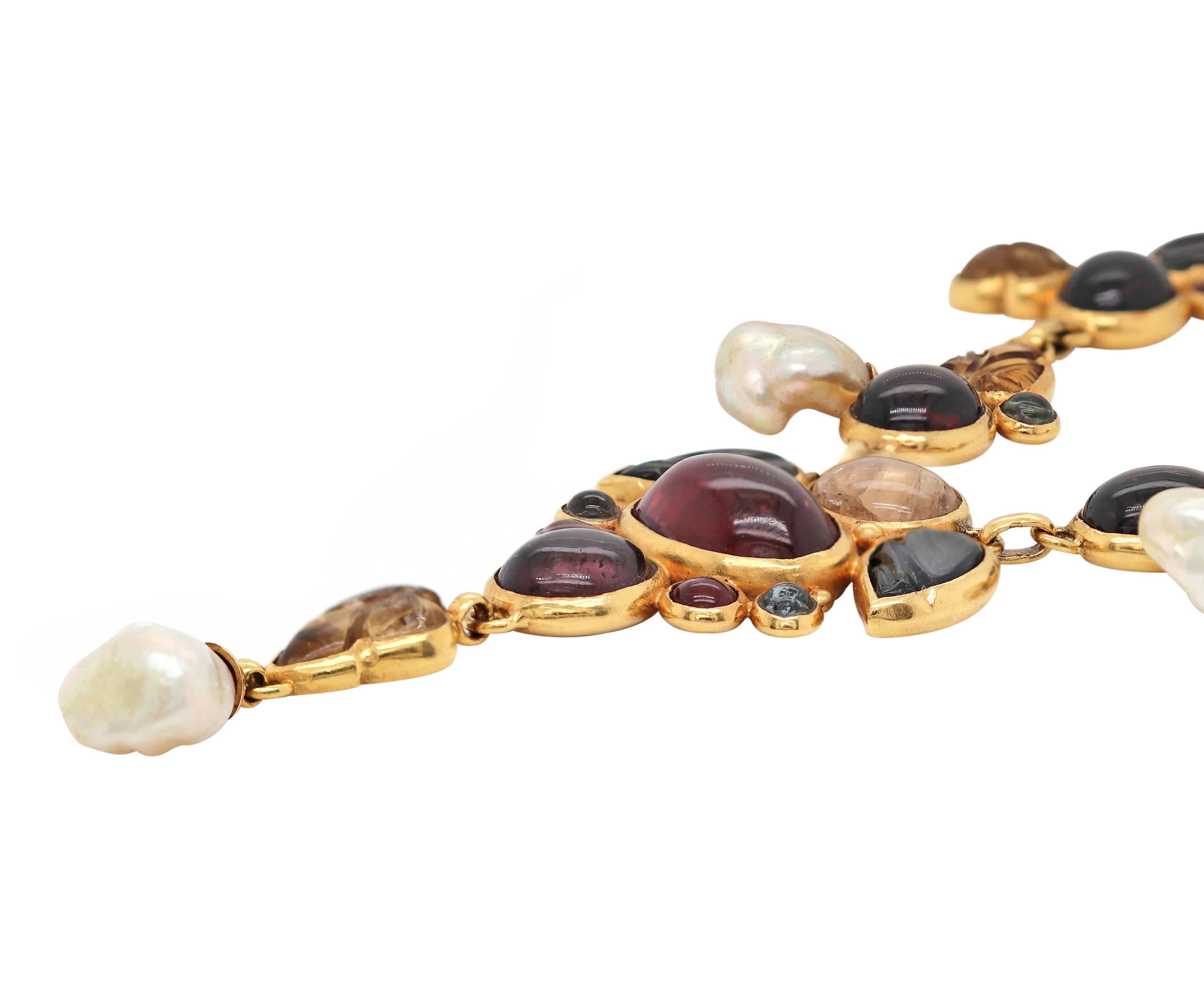This unique necklace is beautifully set with an incredible mix of gemstones and pearls all mounted in 21 carat yellow gold, fitted with a hook and eye closure. The necklace measures 17.5 inches in length and weighs a total of 97.8gr. Made in Bali,
