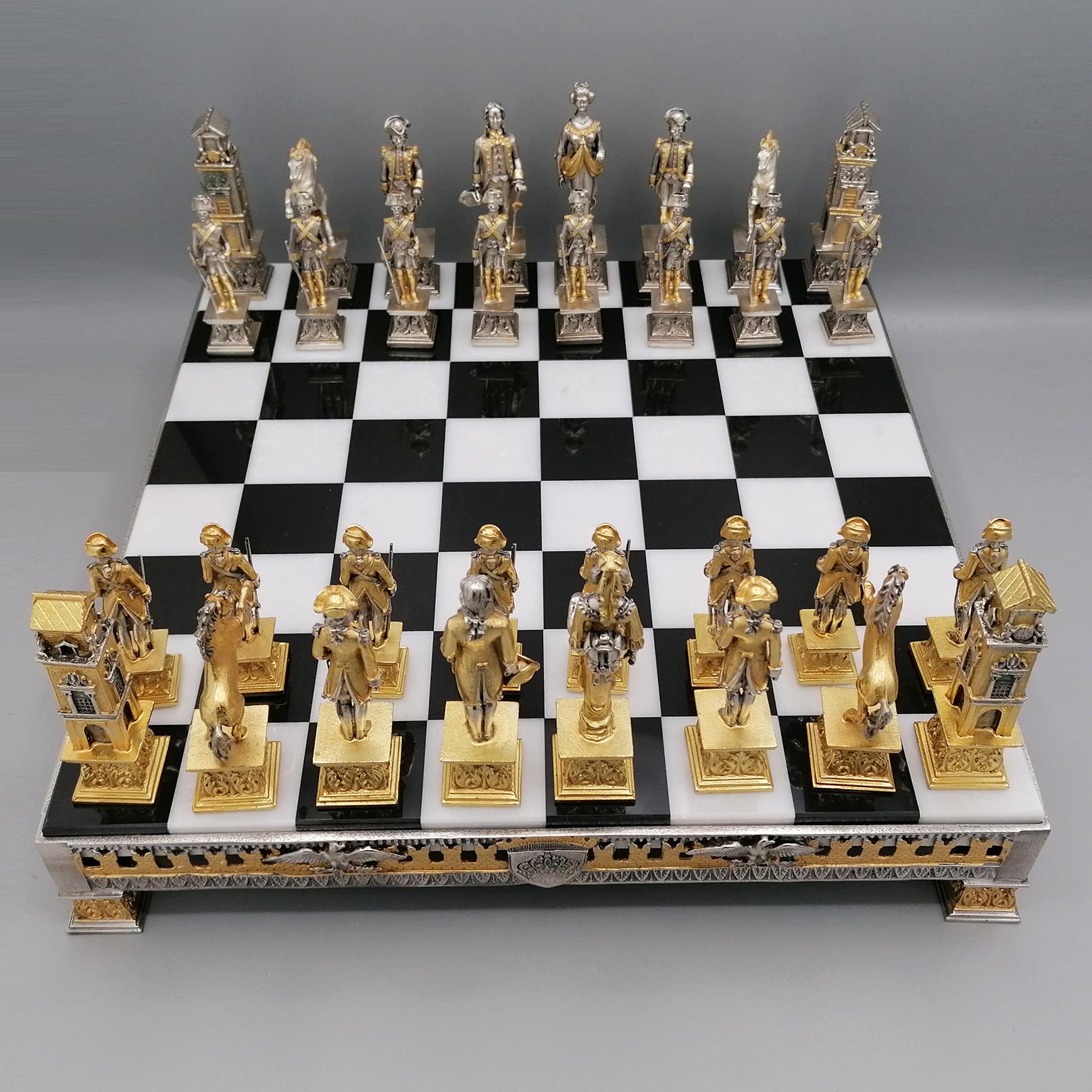 Empire style chess board and game.
The chess game was made of brass with the casting technique.
Subsequently silvered and thick gold-plated with a two-tone finish.
The base is always in two-tone brass with friezes of noble coats of arms and eagles,