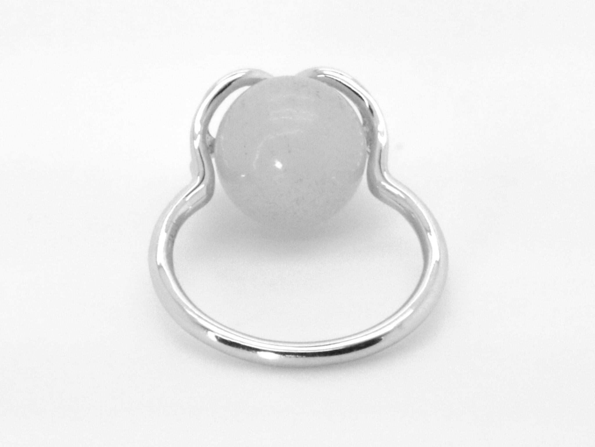 Der Infinite Magic of Gems-Cocktailring ist mit dem Unendlichkeitssymbol gestaltet und mit einem  Weiße Jade, die Edelsteine sind austauschbar. Er ist mit einer halb durchbohrten weißen Jade im Kugelschliff von etwa 8,00 Karat und einem Durchmesser
