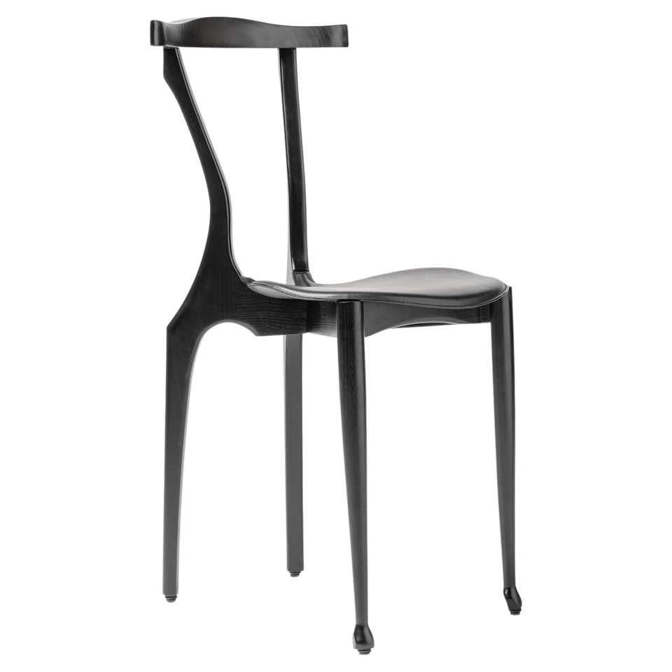 21 Century Black Gaulinetta chair with open pore Lacquered ash in black Finish

Materials: 
Ash, hide

Dimensions: 
D 52 cm x W 42 cm x H 83 cm. (SH 48 cm)

This permits us to make it in a reduced size without giving up any of its comfort.