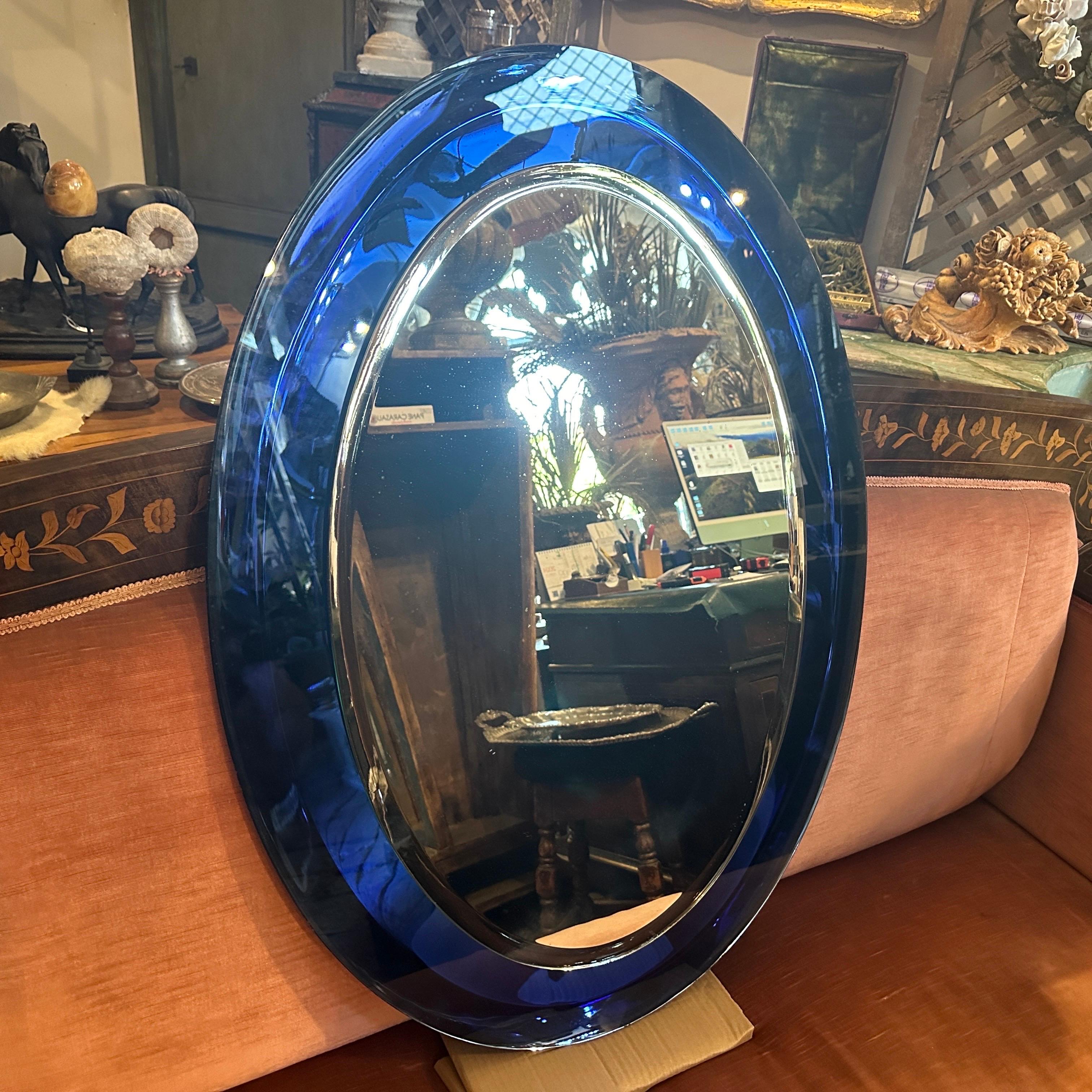 This space age Oval Wall Mirror created by Metalvetro Siena is a notable design piece from the mid-20th century. The mirror features a bold, deep blue frame that embodies the futuristic aesthetic characteristic of the Space Age design movement,