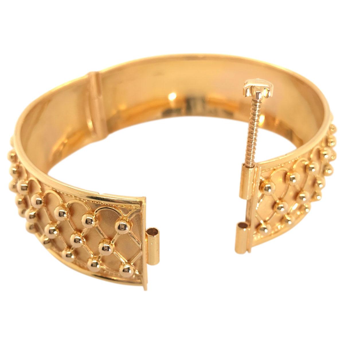 Intricately detailed and beautifully crafted from 21k yellow gold, this bangle has style and sophistication. Feels good on the wrist and has a bold gold look to it. It could be worn alone or it would look just as fabulous layered with other bangles