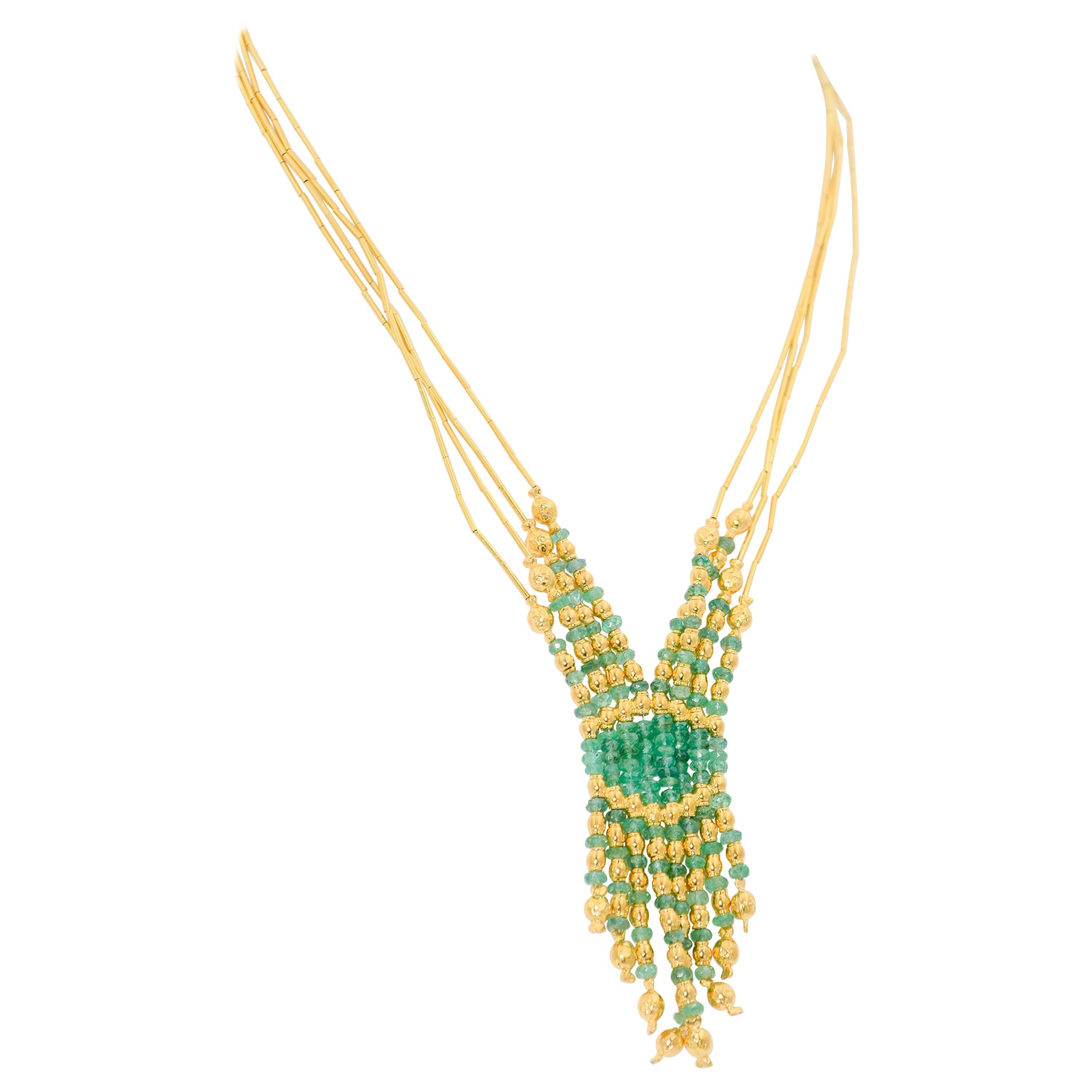 Created in Turkey, this 4 strand Emerald and 21k gold beaded necklace. In Estruscan Revival style, the necklace featured beaded emerald fringe. It measures 18 inches in length.