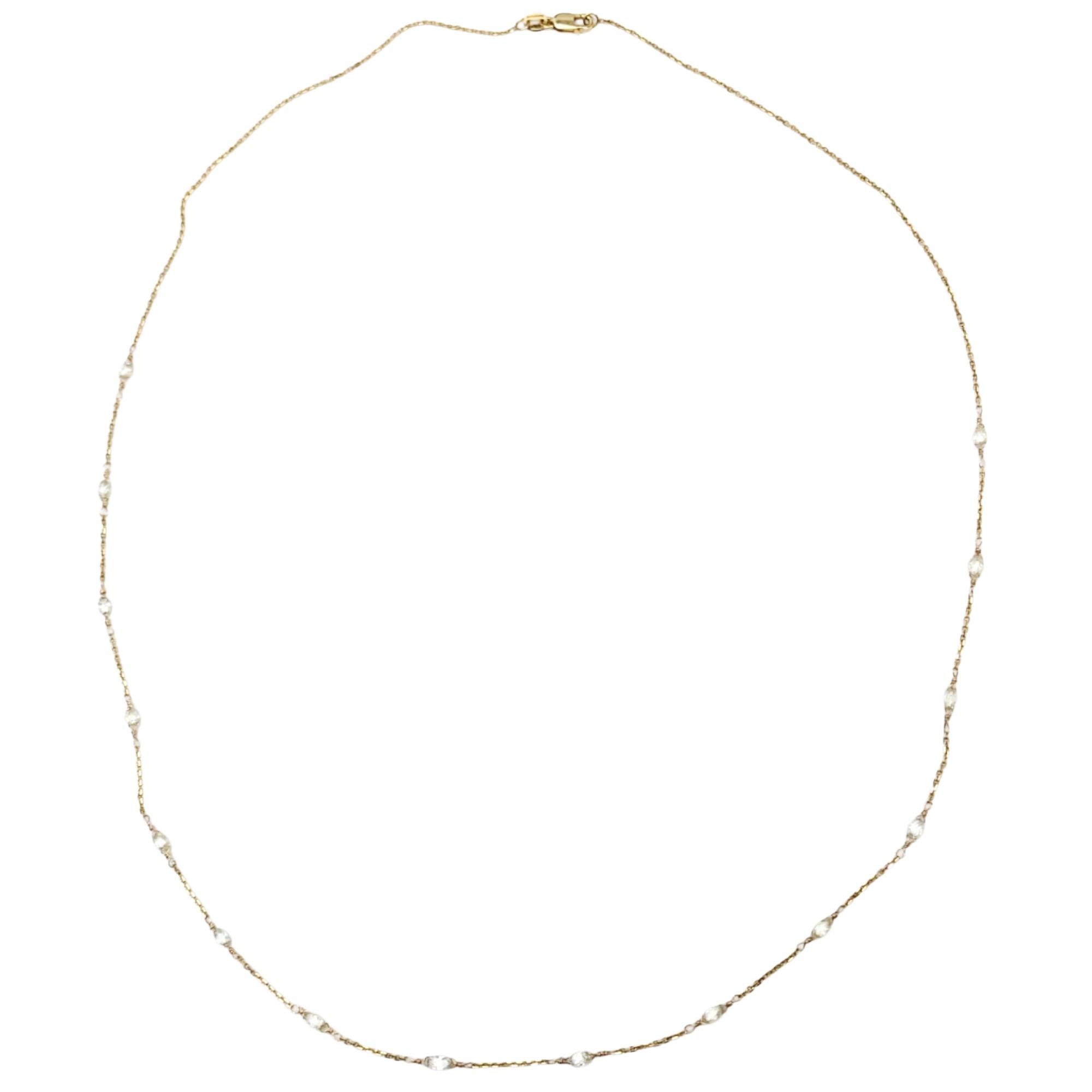 A refined essential with effortless sparkle. This delicate 14 karat yellow gold necklace features faceted white diamond beads linked together and spaced gracefully along the chain, creating a soft shimmer with every movement. The adjustable 21