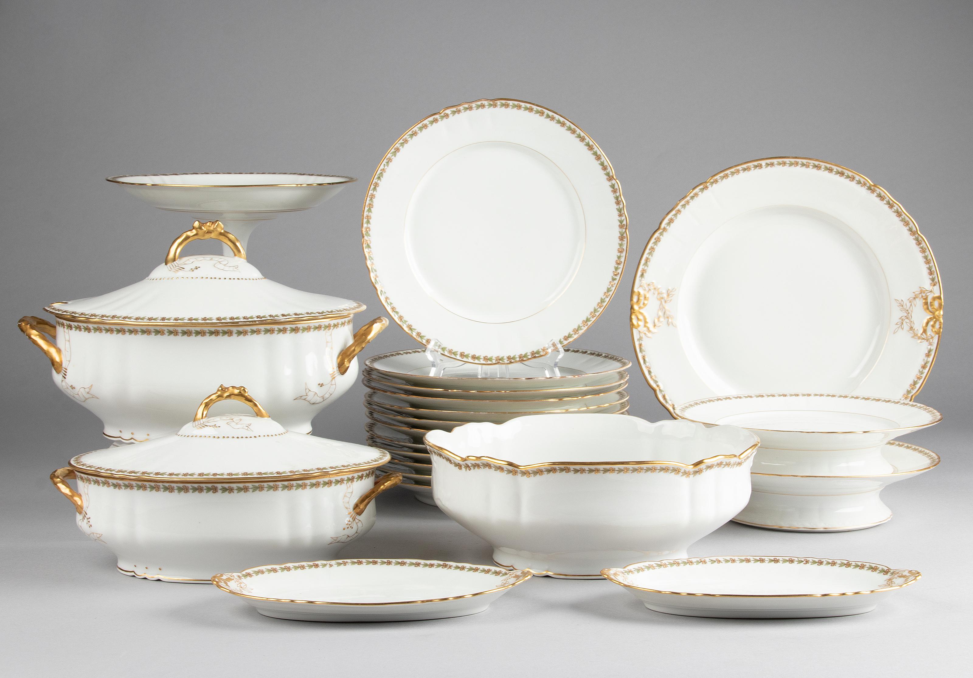 Beautiful set of porcelain tableware from the French brand Limoges. The porcelain is snow-white in colour, decorated with an elegant edge of leaves and ribbons and gold-coloured accents. The service dates from around 1930. The composition of the set