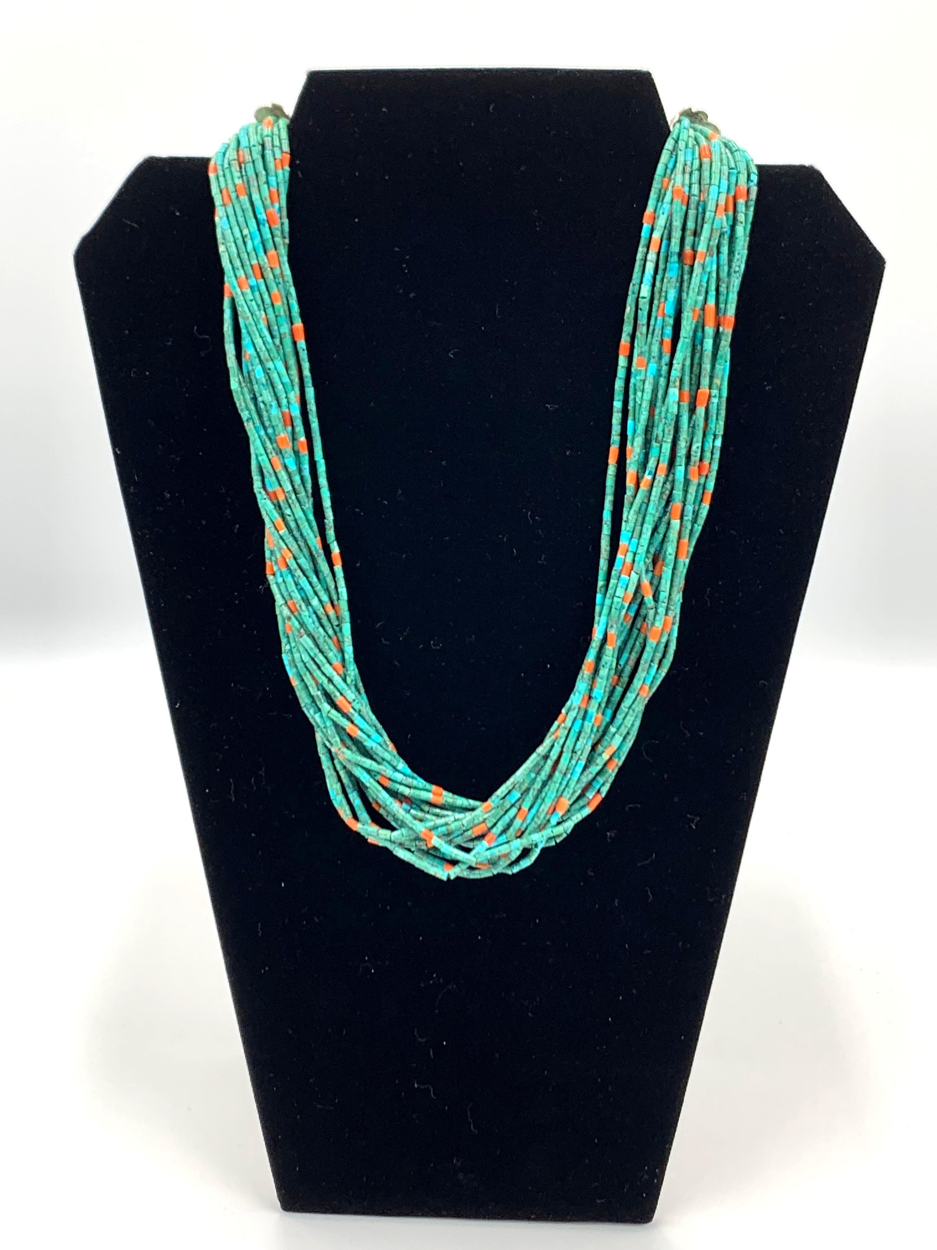 21 strands of turquoise beads interspaced with coral beads. A piece of Aldrich Art by Bennie and Valerie Aldrich.

Sterling silver ends, Aldrich tag and lobster clasp  
20.5
