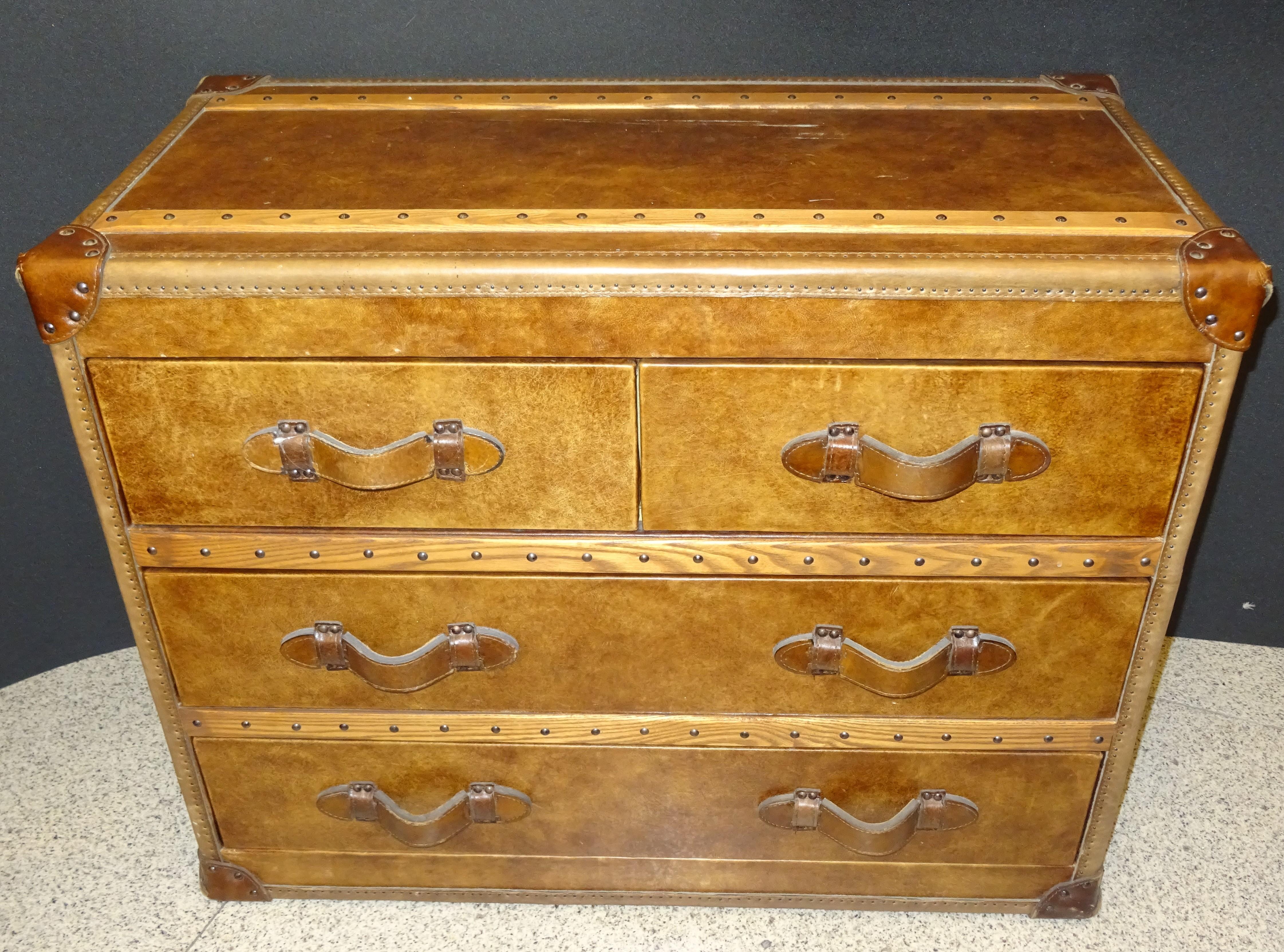 Amazing Flamant French wood and leather chest of drawers, in a very good condition, English colonial style trunk. In an elegant cognac color with the interiors draws upholstered in a soft green color.
It has handles and 4 draws.
It comes from