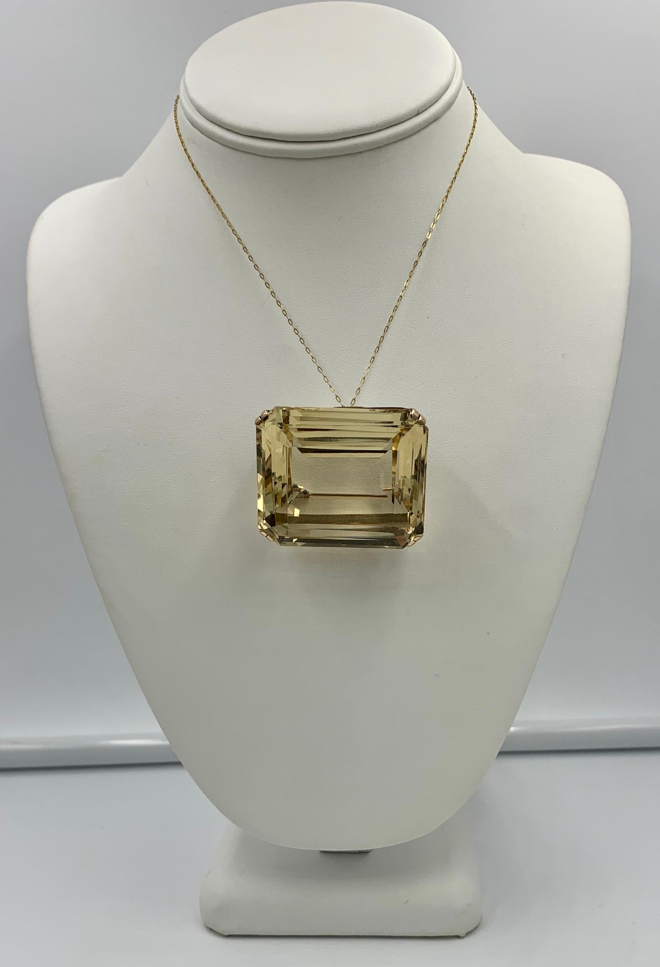 An absolutely magnificent monumental 210 Carat emerald cut Citrine Pendant or Brooch in a classic setting in 14 Karat Gold.  The pendant brooch is a testament to the stunning design of the Retro Mid-Century period.  The monumental 210 Carat Citrine