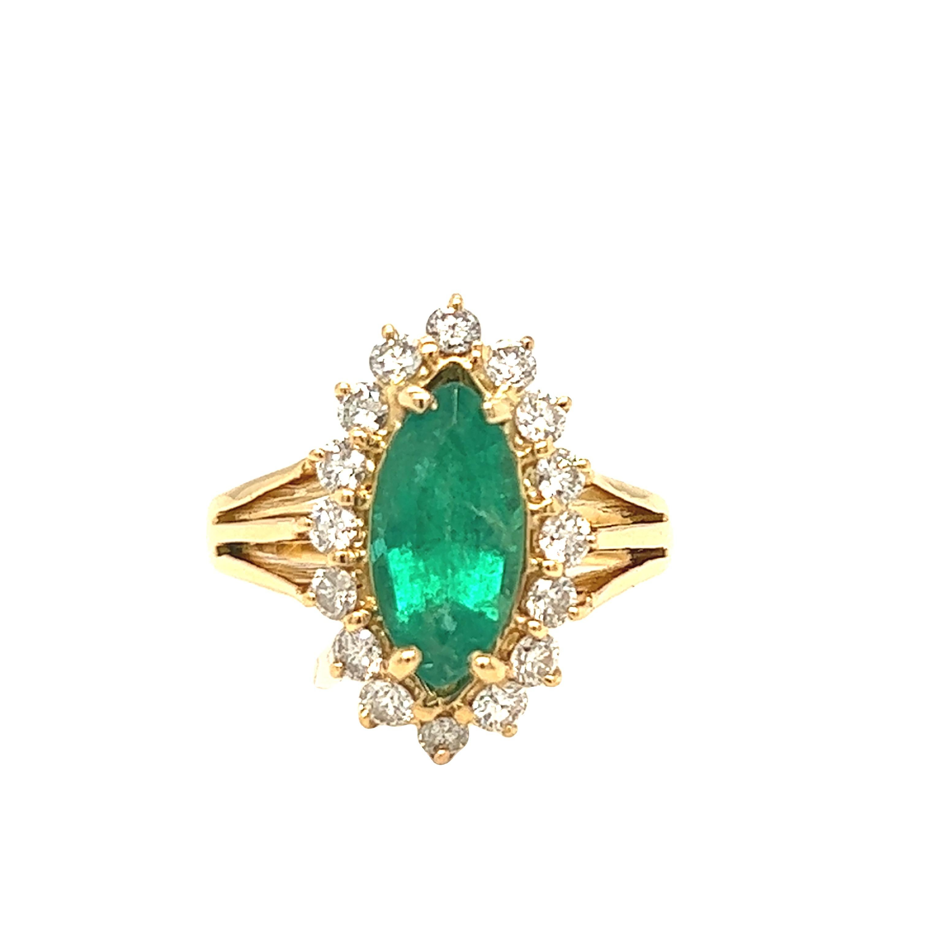 As a perfect cocktail ring or colored stone engagement ring, this romantic ring is crafted in 18K yellow gold with a split shank and prongs holding a vibrant marquise emerald weighing approximately 2.10 carats. The center emerald is enhanced by 16