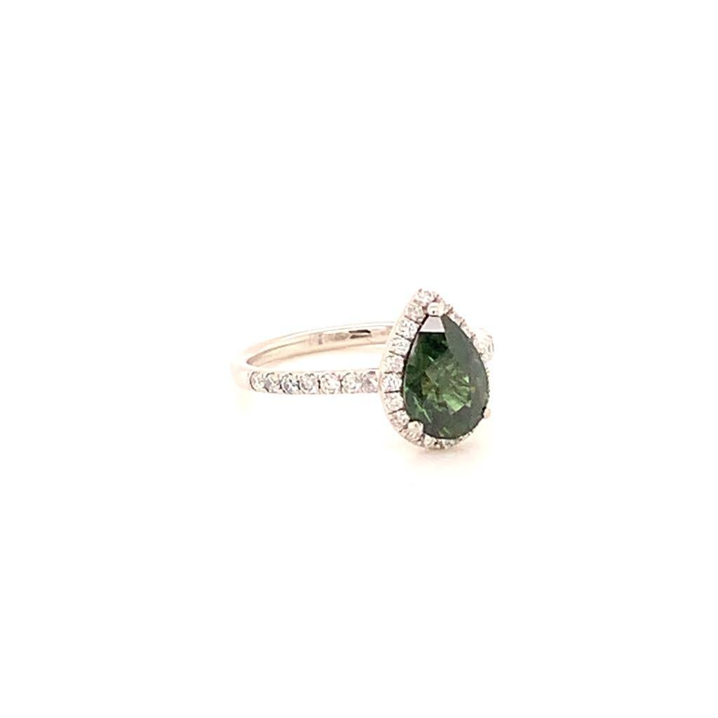 This beautifully elegant ring is made of a 2.10 Carat Pear Shaped Green Sapphire surrounded by scintillating round brilliant Diamonds weighing 0.35 Carats set in Platinum. The stark contrast between the deep green hues of the sapphire and the