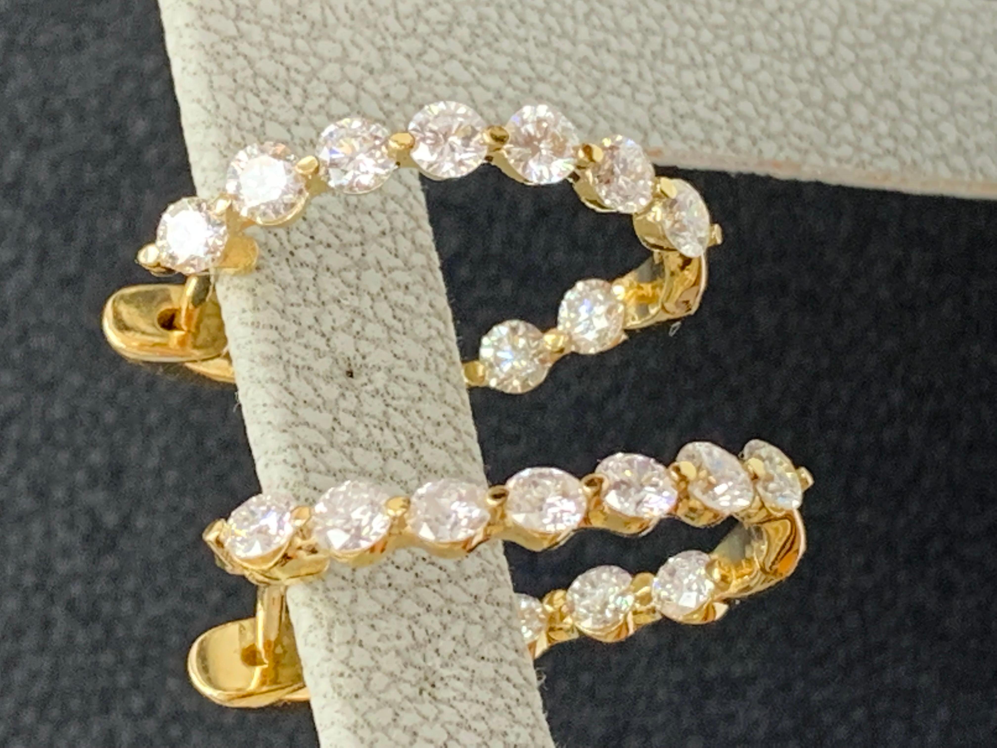 A chic and fashionable pair of hoop earrings showcasing brilliant-cut round diamonds, set in 14k yellow gold. 22 Round diamonds weigh 2.10 carats in total. A beautiful piece of jewelry.


All diamonds are GH color SI1 Clarity.
Style is available in