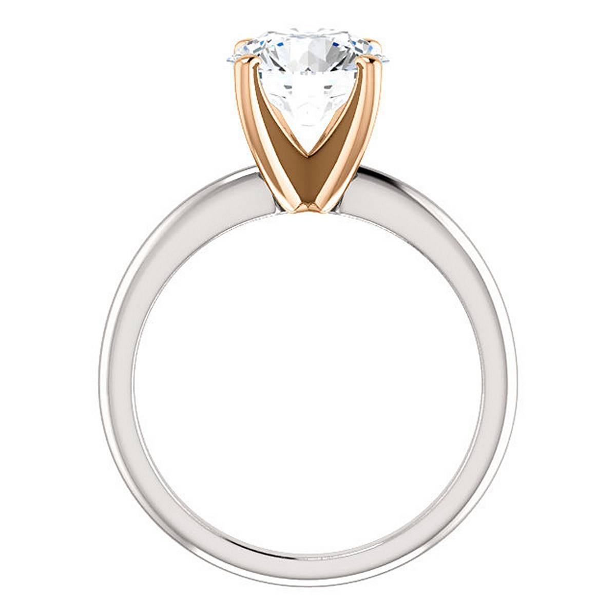 A very fine 2.10 carat Round Brilliant cut diamond in a platinum and 18k rose gold Solitaire ring.
The center stone is E color VS1 clarity set in a chic polished fine platinum ring and 18k rose gold simple four prong solitaire style mounting. GIA