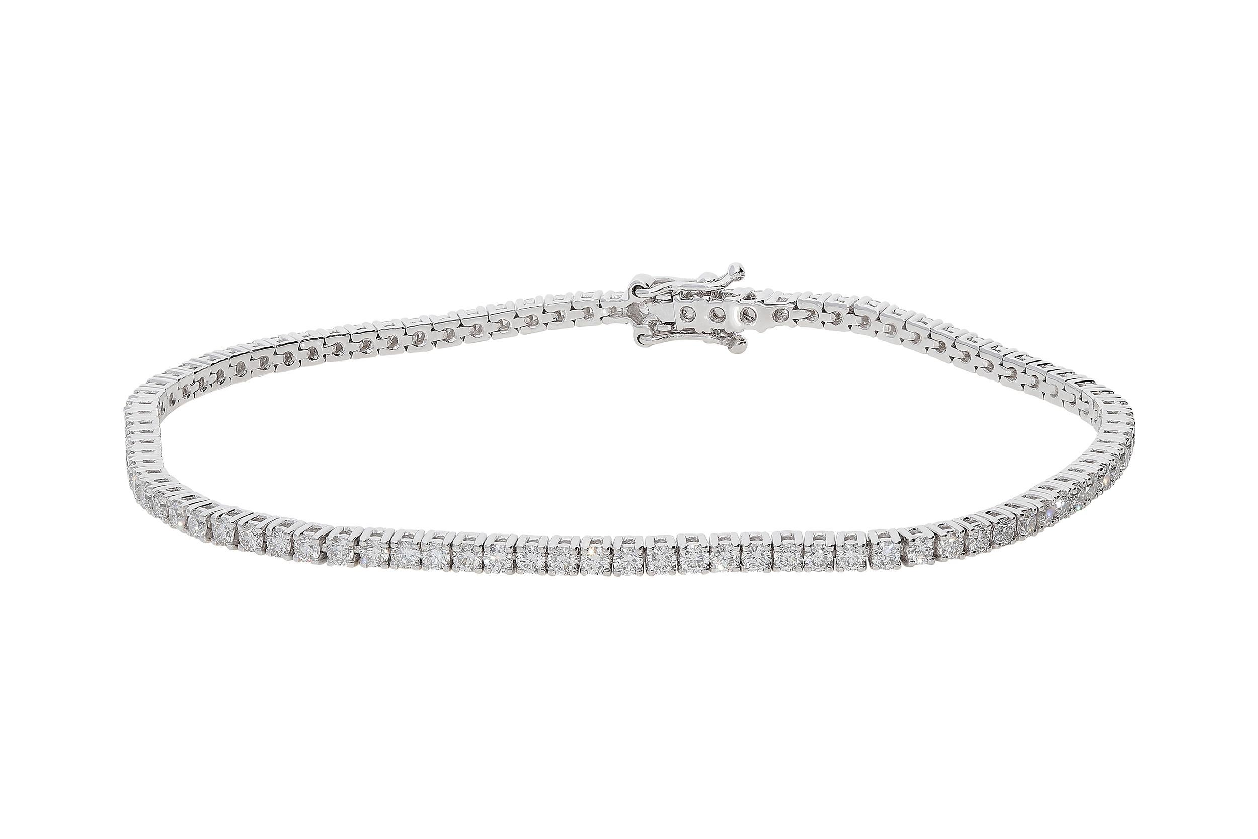 Tennis bracelet in 18kt white gold for a weight of 7,70 grams and white round brilliant diamonds color G clarity VS for 2,10 carats. The length is 17.50 centimeters and the width is 2.20 millimeters. Double safety eight on sides completes the
