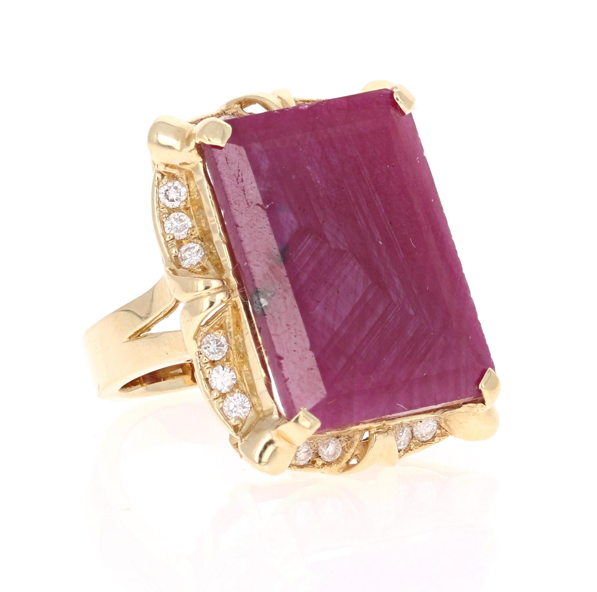 This ring is truly a one of a kind beauty with a Victorian Inspired edge!
There is a large genuine and natural Rectangular Cut Ruby set in the center of the ring that weighs 20.50 carats.  
It is surrounded by 20 Round Cut Diamonds that weigh 0.51