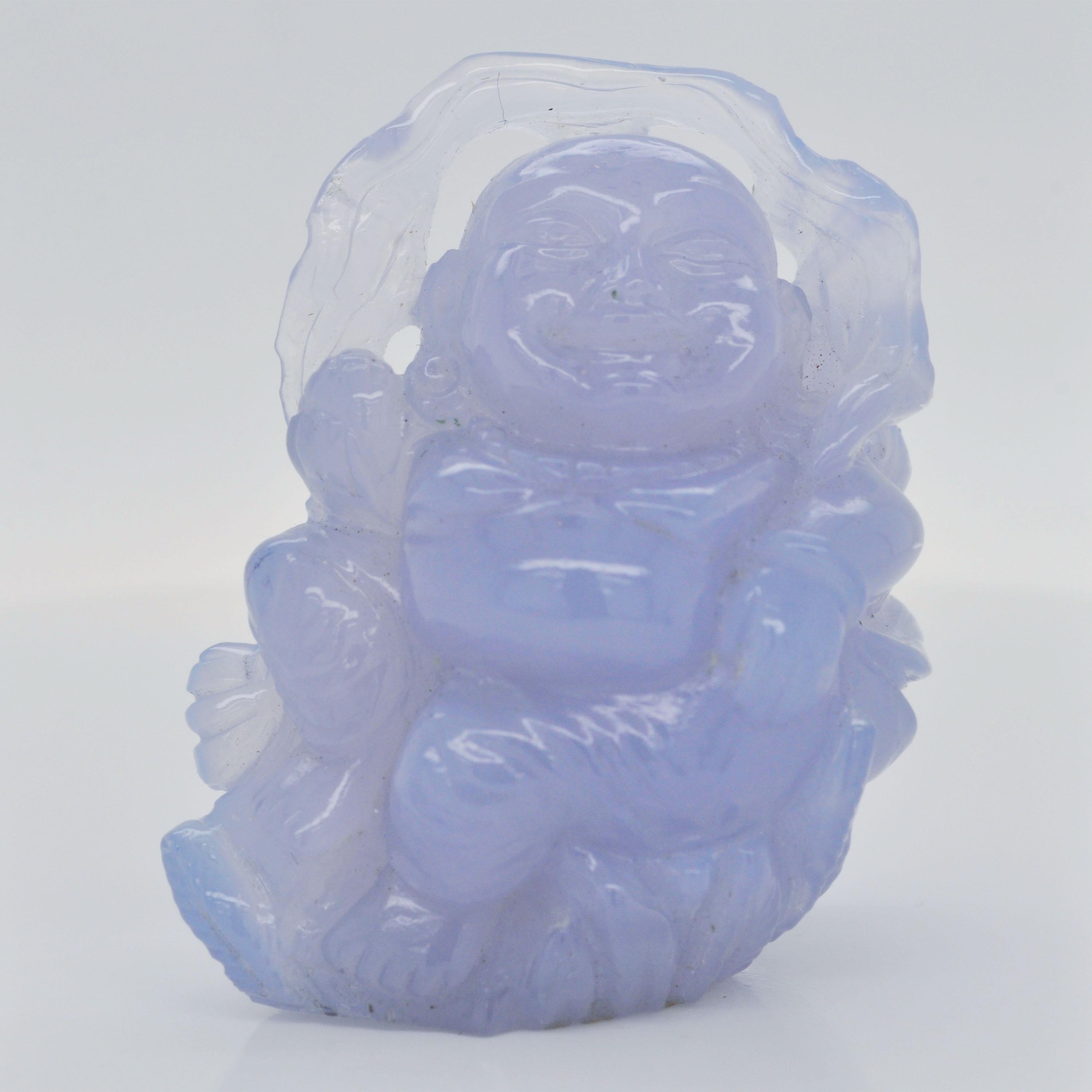 The 210.27-carat Blue Chalcedony hand-carved Buddha carving is a stunning, one-of-a-kind piece, ideal for use as a pendant necklace or as a decorative item. This beautiful carving showcases the serene and peaceful figure of the Buddha, skillfully