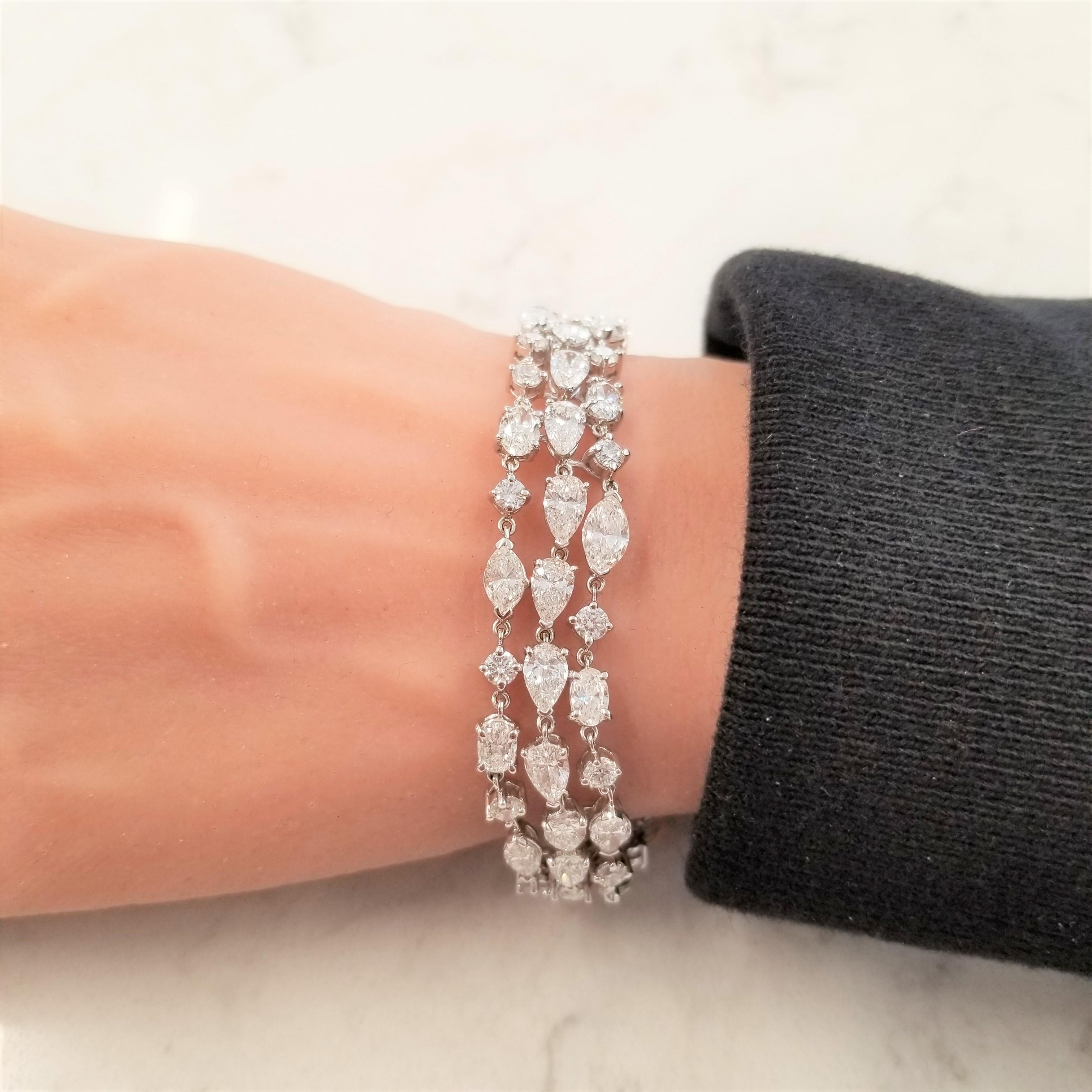 Pears, ovals, marquises, and round diamonds come together in pitch perfect harmony to create this spectacular diamond bracelet. Magnificently handcrafted in 18 karat white gold, this piece boasts a combined weight of 21.05 carat total weight. This