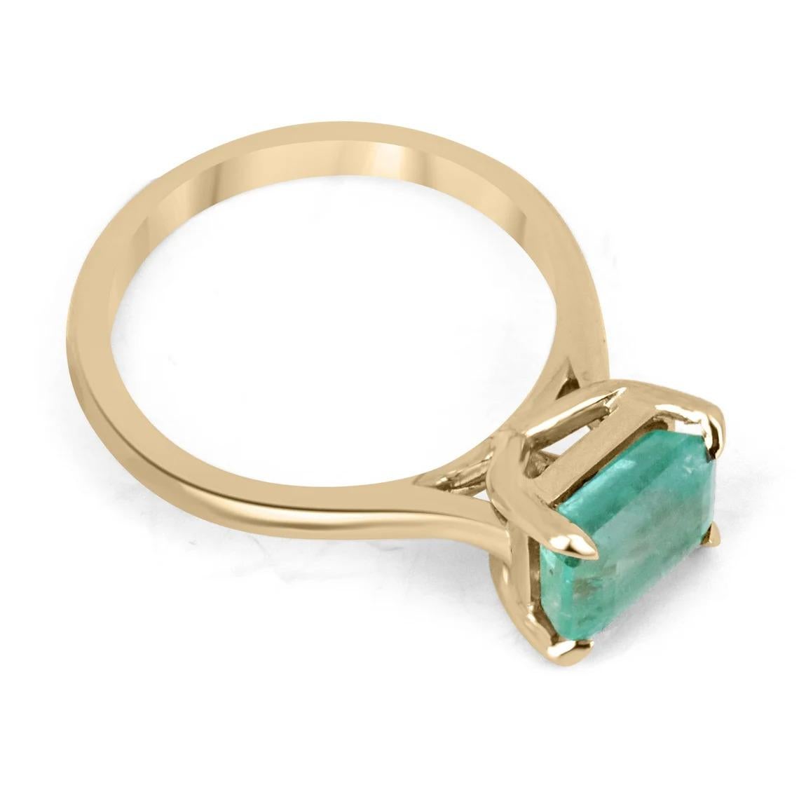 Displayed is a lovely solitaire emerald ring. This piece carries a stunning natural emerald from the origin of Zambia. The gemstone displays a light green color with good transparency and eye-catching luster. Set in an East to West, solitaire