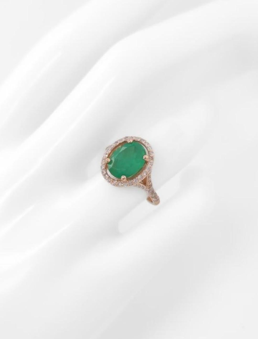 This is the most gorgeous and unusual cocktail ring. 

A vibrant oval cut natural emerald which is surrounded by round brilliant cut pink diamonds.  This natural emerald weighs 2.10ct and is a beautiful vivid green in colour.    Secured in a four