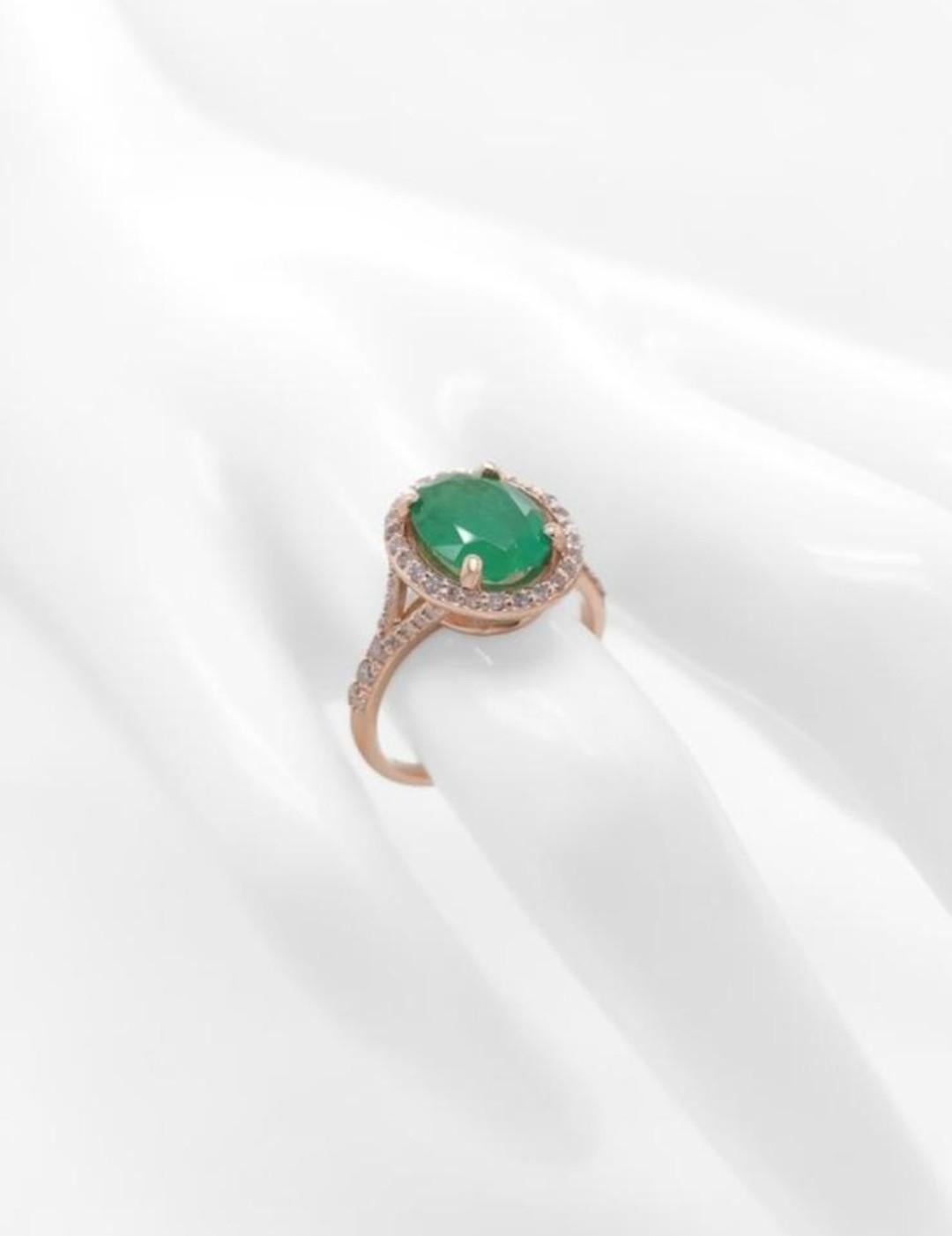 Contemporary 2.10ct Oval Emerald and Diamond Halo Ring For Sale