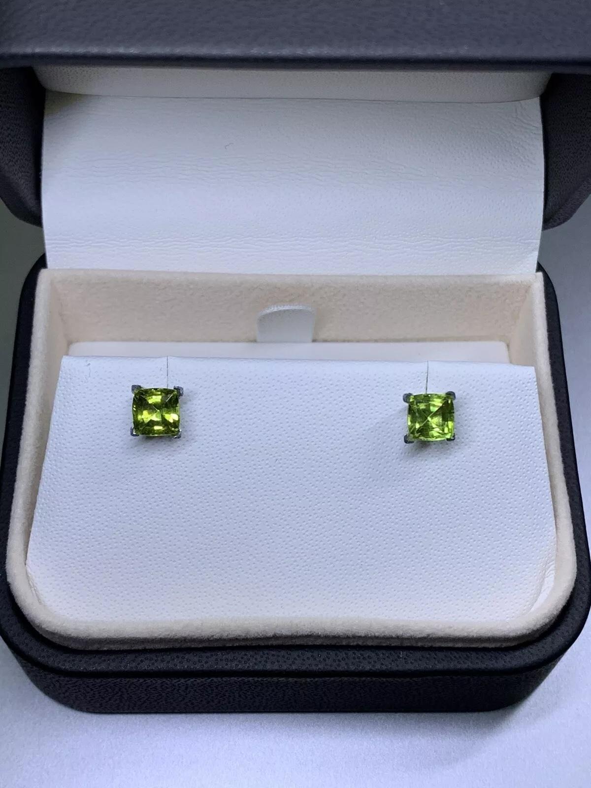 2.10ct Peridot green cushion stud earrings in 18ct white gold.

Beautiful matching pair green peridot gemstone in 18k white gold.

Hallmarked.

Peridot natural untreated 2.10ct total weight cushion cut.

Box and valuation included.
