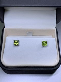 2.10ct Peridot green cushion stud earrings in 18ct white gold.