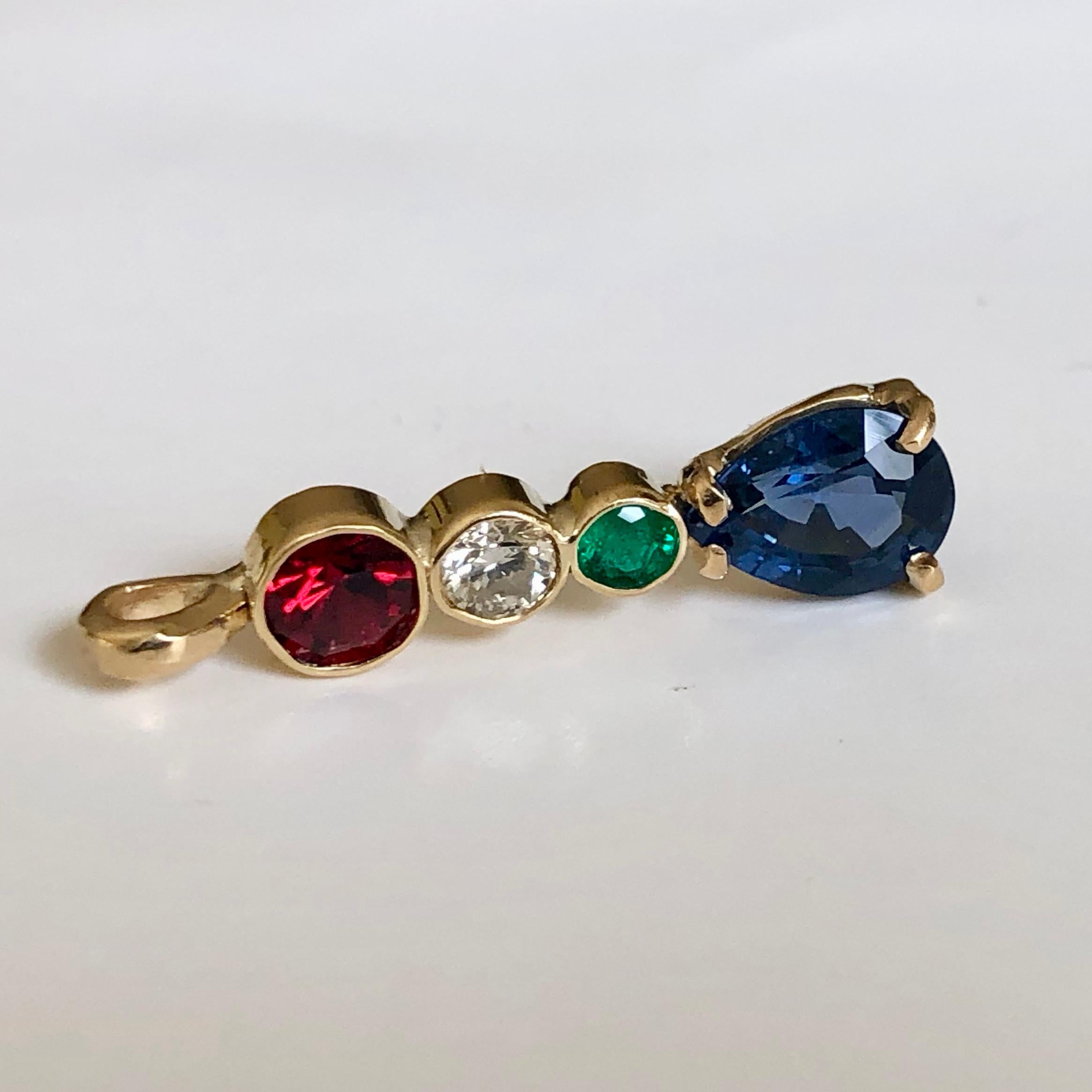 Fine 18k Yellow Gold Multi-Stone Pendant
Very unique pendant set with 1.45ct blue sapphire pear cut, .40ct red spinel round cut, .12ct diamond round cut, and .10ct emerald round cut. Totaling 2.10 carat gemstone.
Pendant Length: 1 Inches
Style: