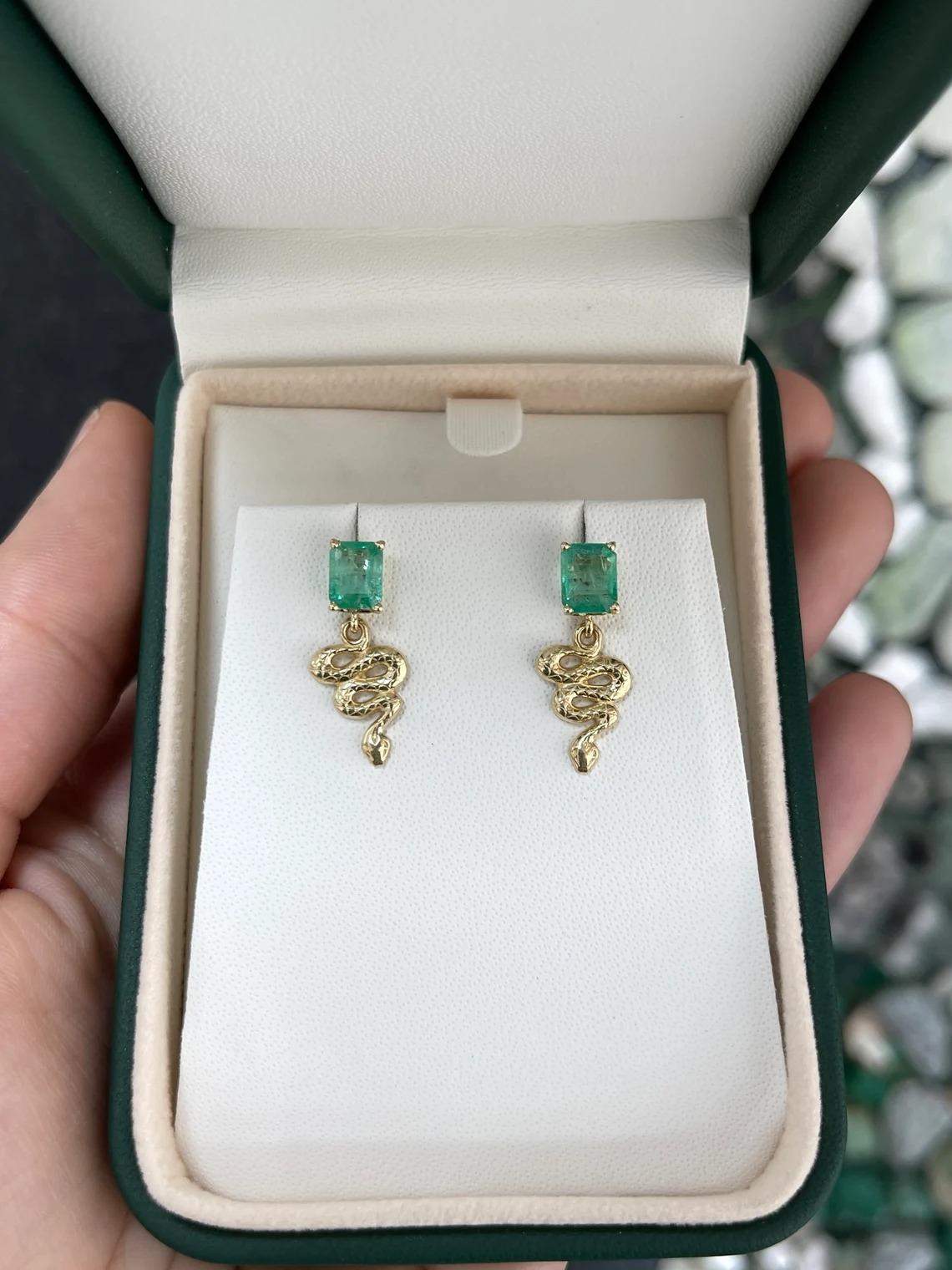 These captivating emerald stud earrings feature emeralds with a combined weight of 2.10 carats. The emeralds showcase an emerald cut, displaying a mesmerizing medium green color and unique characteristics that enhance their allure. Set in a secure