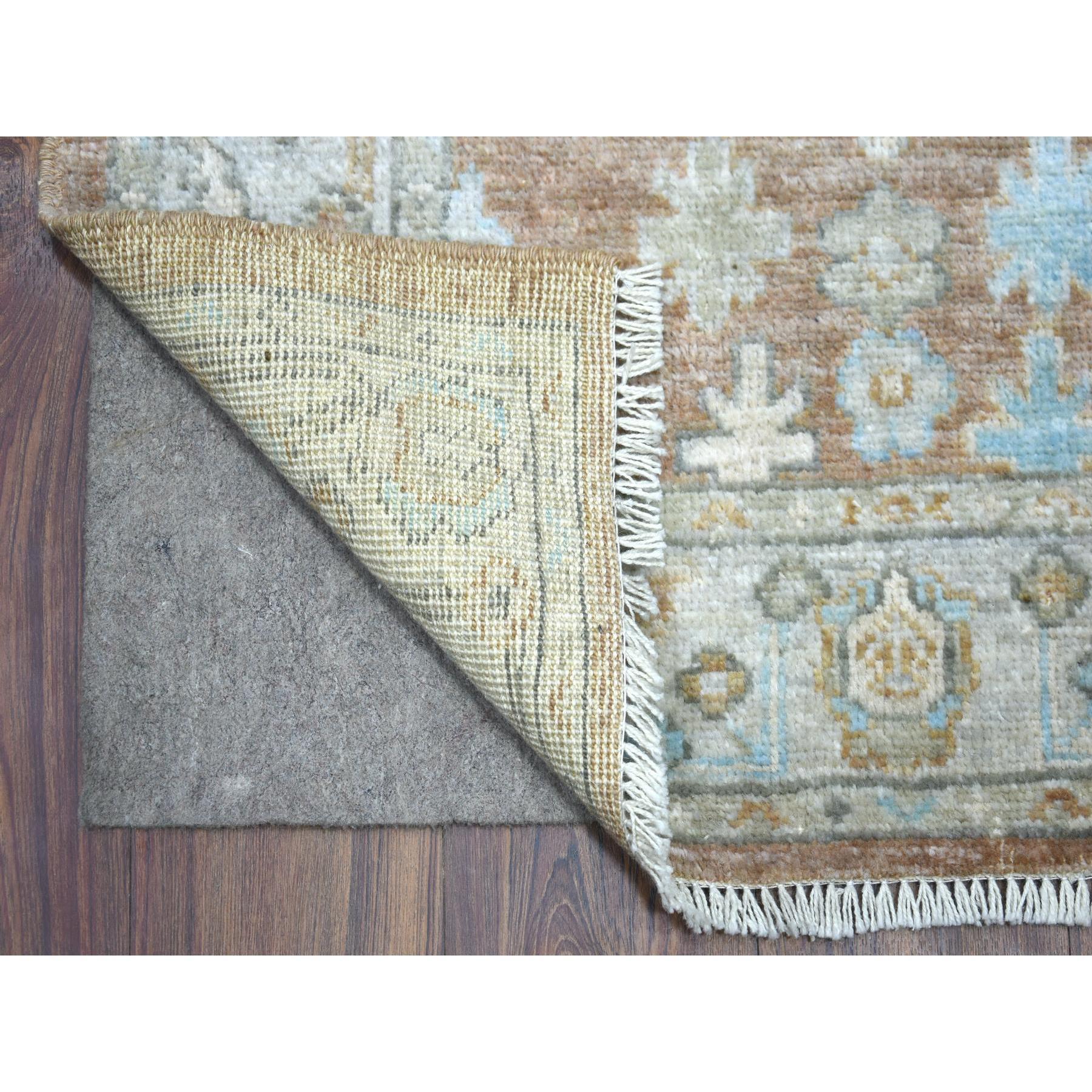 Si tratta di un autentico tappeto orientale Runner in lana afgana annodato a mano, dal design aperto e fluente, di colore marrone noce, con tinture naturali Ushak. È stato annodato per mesi e mesi con tecniche artigianali di tessitura secolari da