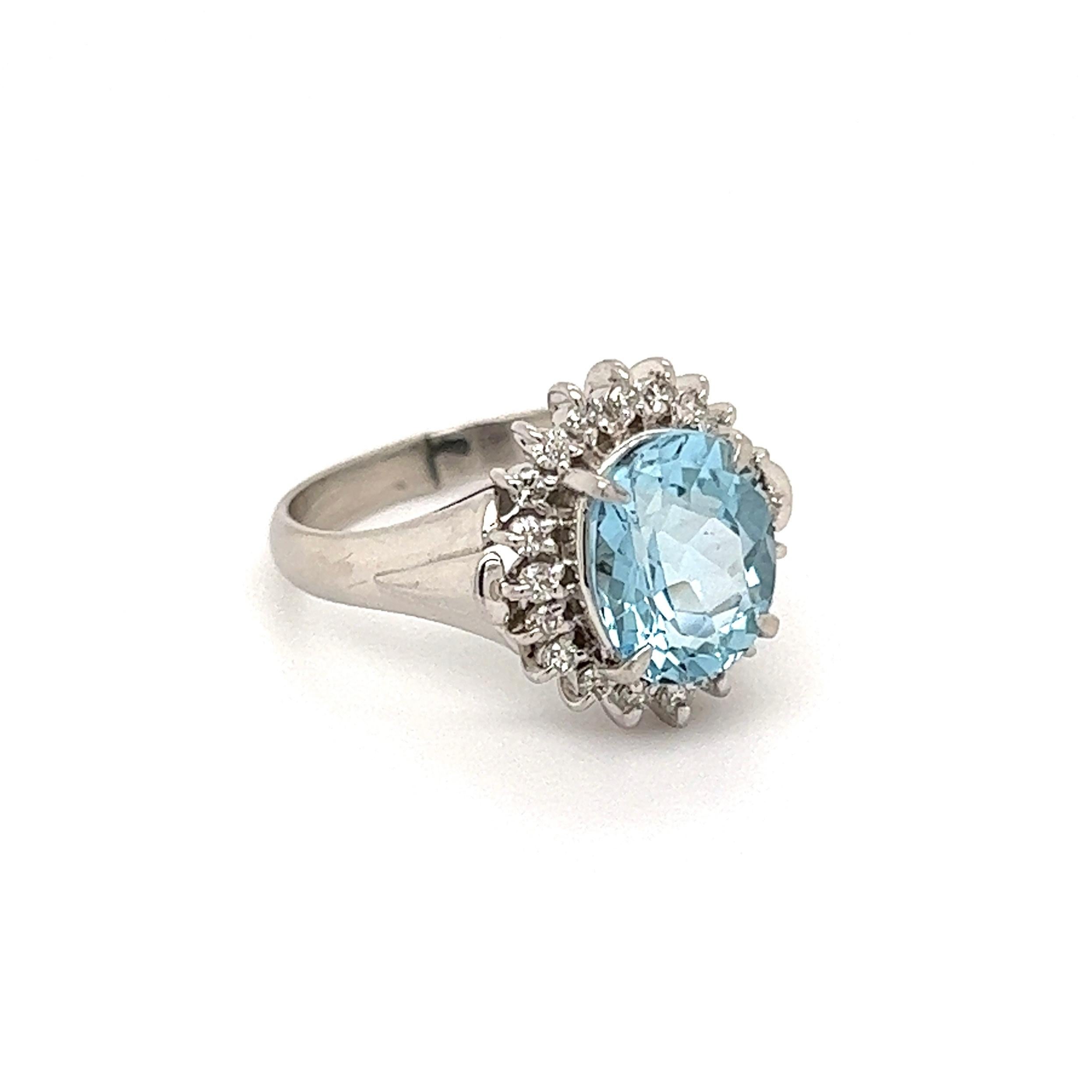 Simply Beautiful! Aquamarine and Diamond Platinum Cocktail Ring. Center securely Hand set with an Oval Aquamarine, weighing approx. 2.11 Carats surrounded by Diamonds weighing approx. 0.23tcw. Hand crafted platinum mounting. Measuring approx. 0.98”
