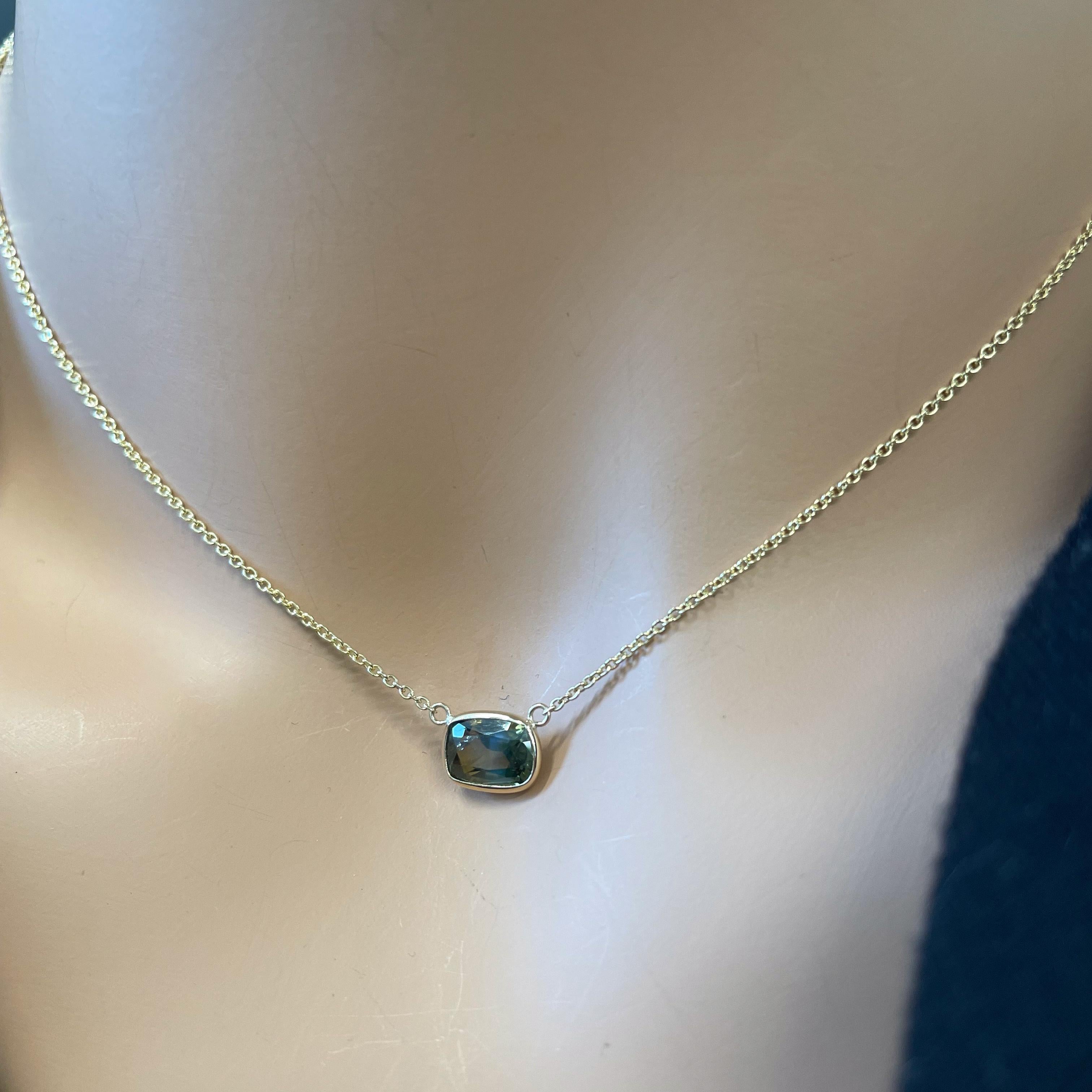 The 2.11 carat Cushion Cut Green Alexandrite Necklace in 14K Yellow Gold showcases the captivating allure of natural gemstones and the artistry of fine jewelry, making it a true testament to both beauty and sophistication The Alexandrite gemstone is
