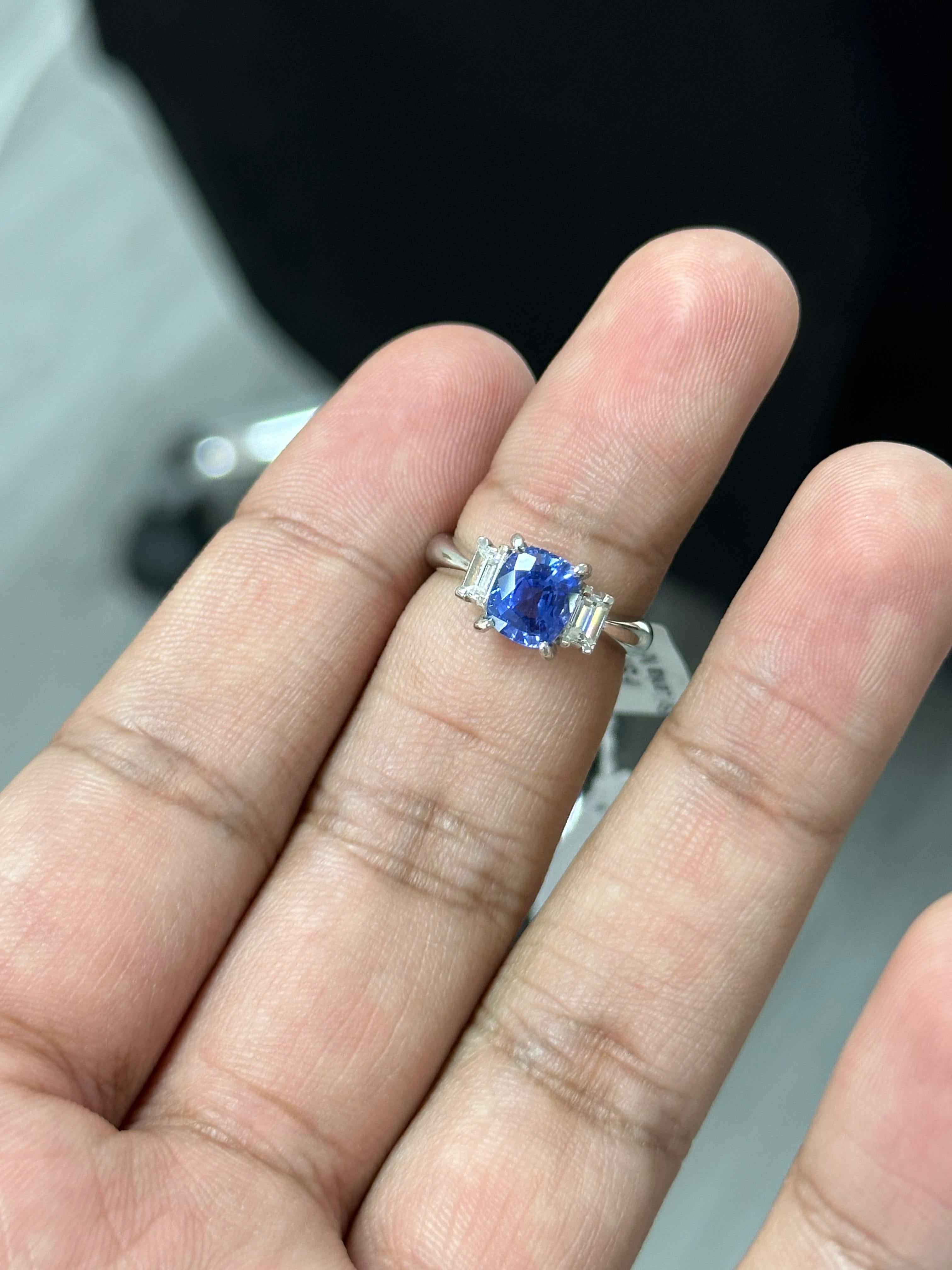 Introducing the epitome of luxury and sophistication, behold the breathtaking three-stone, Sapphire and Diamond Ring, a true marvel in the world of fine jewelry. Crafted with precision and passion, this extravagant piece exudes opulence from every