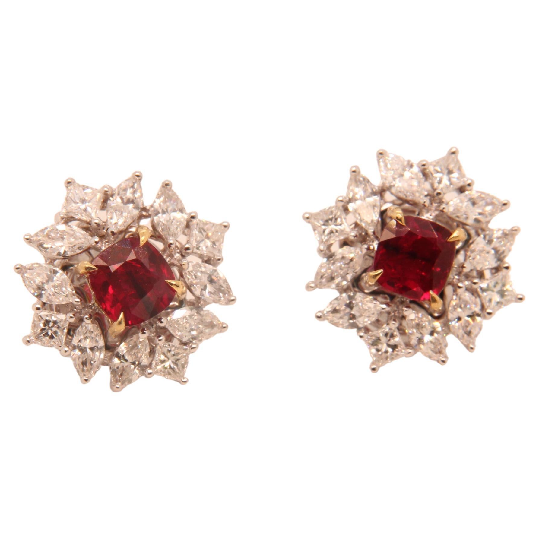 A brand new ruby and diamond earring by Rewa. The Burmese 'Pigeon Blood' ruby weigh 1.11 and 1.00 carat each and they are both certified by Gem Research Swisslab (GRS). The rubies are surrounded by 2.22 carat diamonds studded on 18k white gold 6.44
