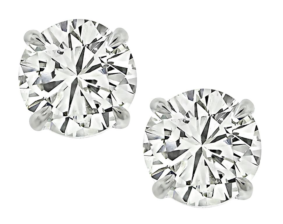 This is an elegant pair of 14k white gold stud earrings. The earrings feature sparkling round cut diamonds that weigh approximately 2.11ct. The color of these diamonds is J-K with VS1 clarity. The earrings measure 6.5mm in diameter and weigh 1.6
